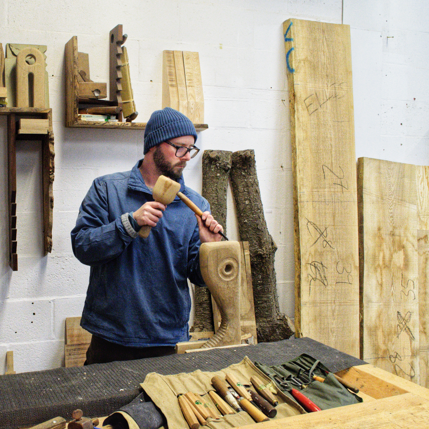Ellis James Stacey, Oxford-based furniture maker, hand carving bespoke wooden furniture in his studio. Discover traditional craftsmanship and custom handmade furniture in Oxfordshire.