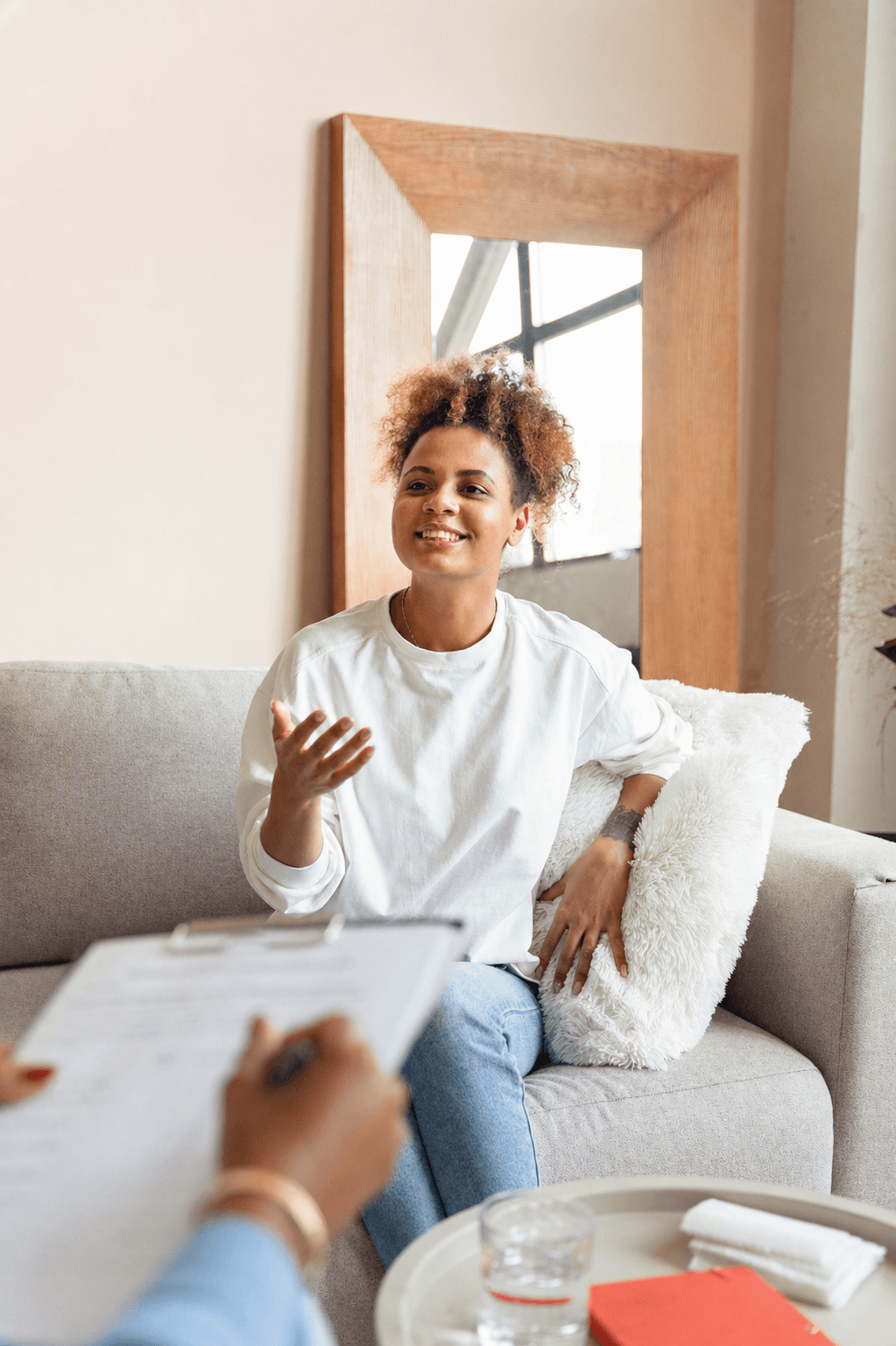 Woman sitting on a couch talking to a therapist