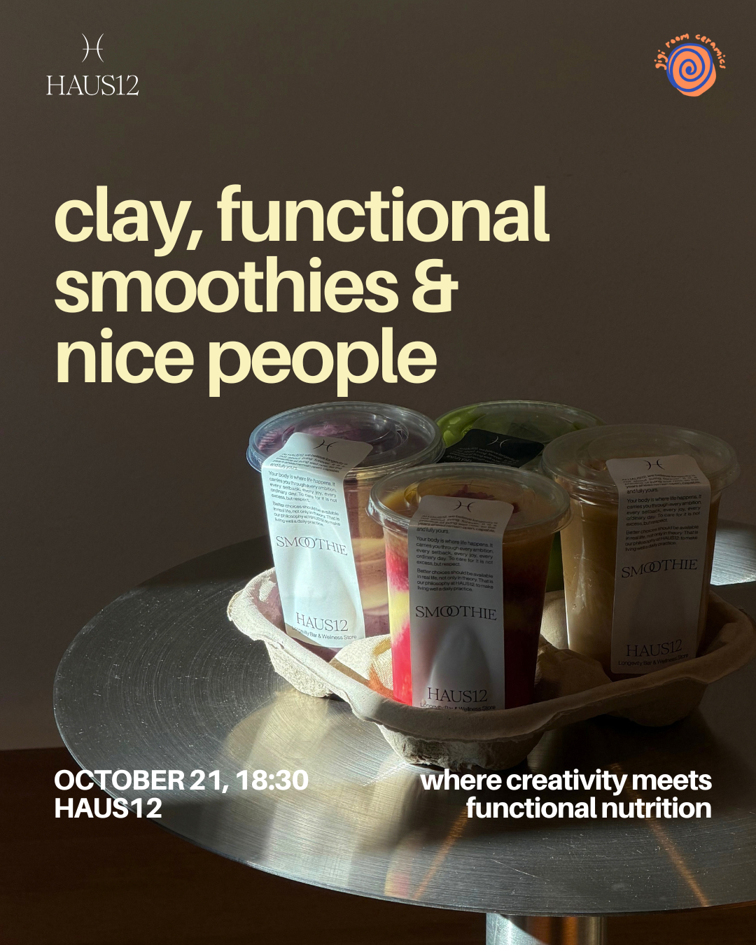 Four smoothie cups in a tray with a label, placed on a metallic table, with sunlight accentuating their colors.