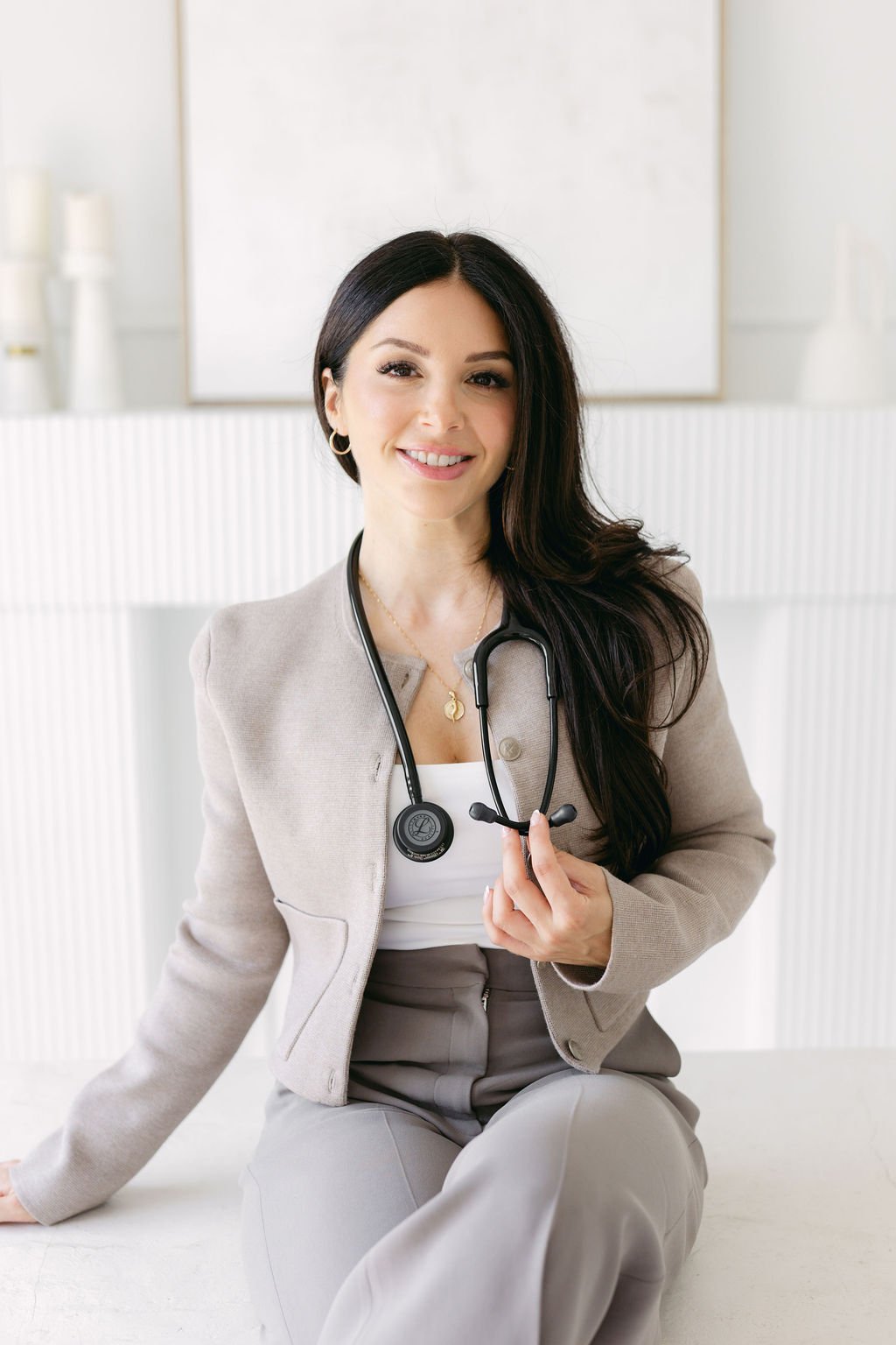 Licensed Nurse Practitioner Cassie Cimino poses wearing a stethoscope in her clinic Contour Medical Aesthetics & Wellness in St. Catharines.