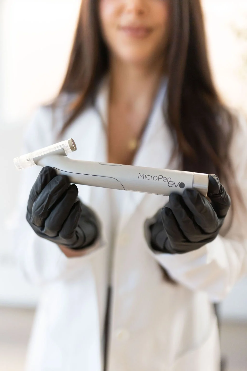 Licensed Nurse Practitioner Cassie Cimino holding the pen she uses to perform microneedling procedures in St. Catharines