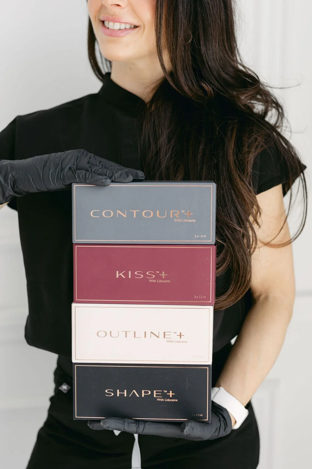 Licensed Nurse Practitioner Cassandra Cimino is holding available lip filler products in St. Catharines at Contour Medical