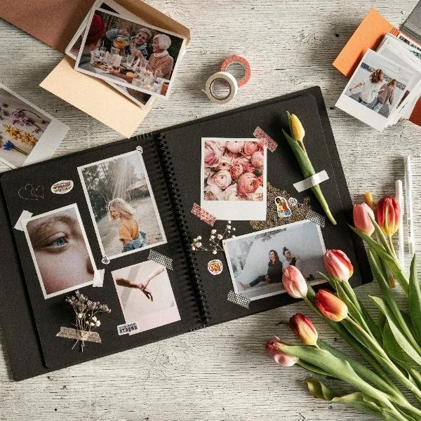 “Open journal with photographs, flowers, and personal memories arranged on a table, symbolizing self-reflection and soul journaling.”