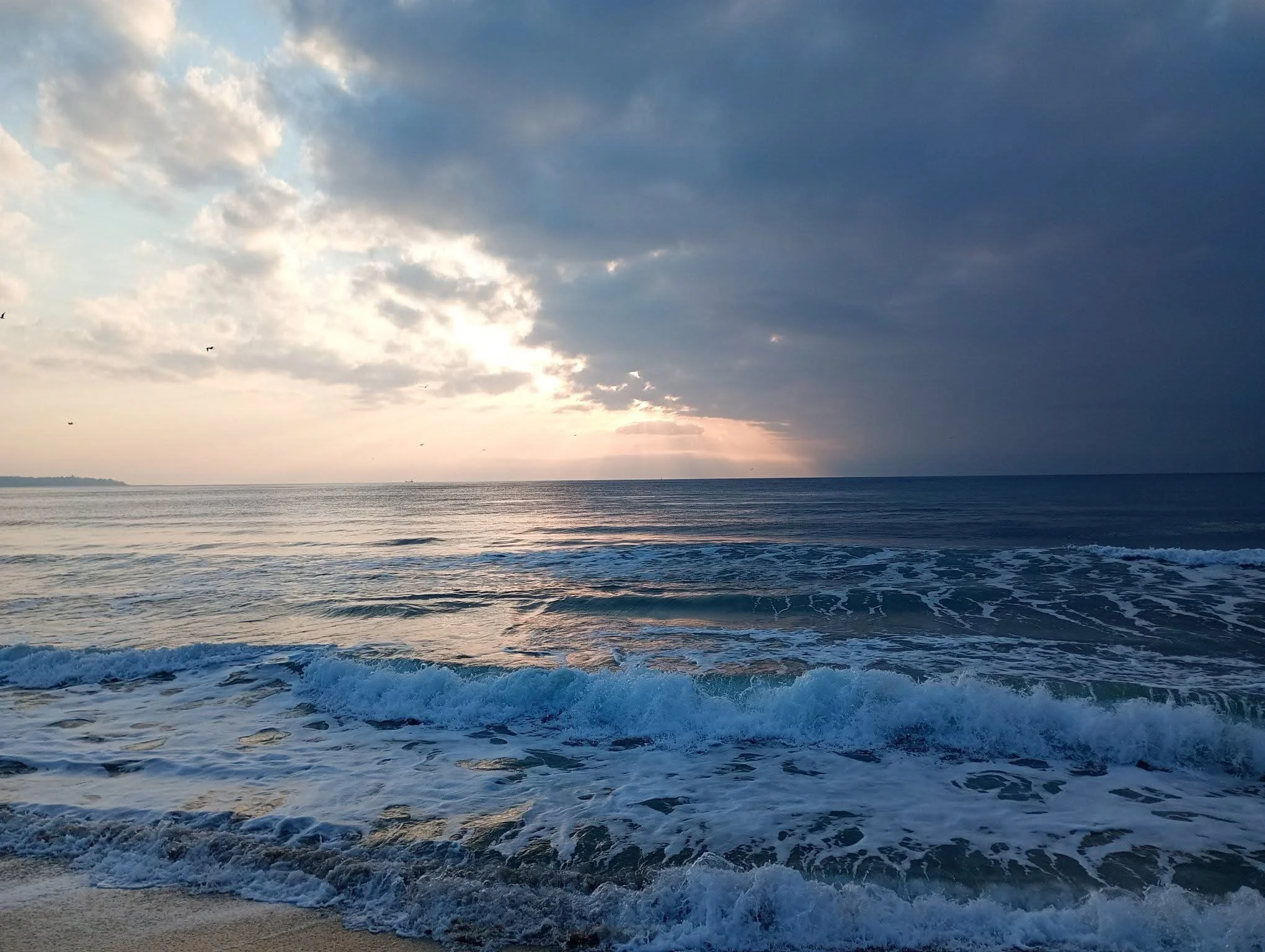 Ocean waves beneath a clearing sky, symbolizing renewal, restored energy, balance, and the return of vitality.