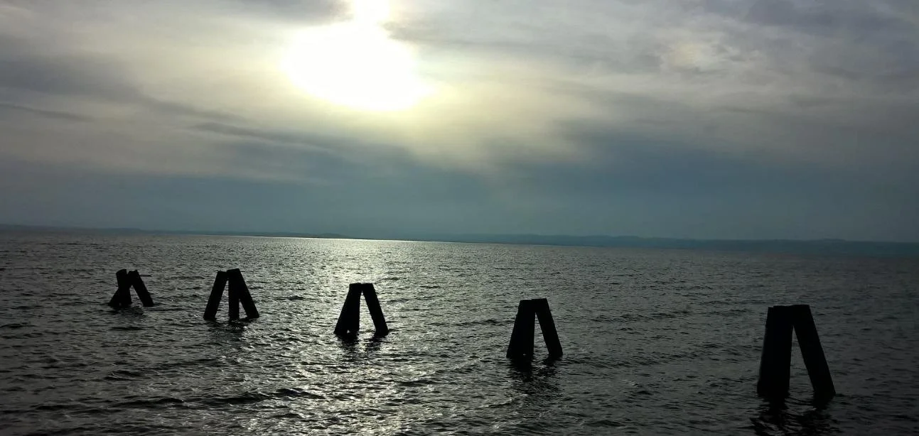 Sunlight over the sea, reflecting the peace and perspective of the Reiki Principles