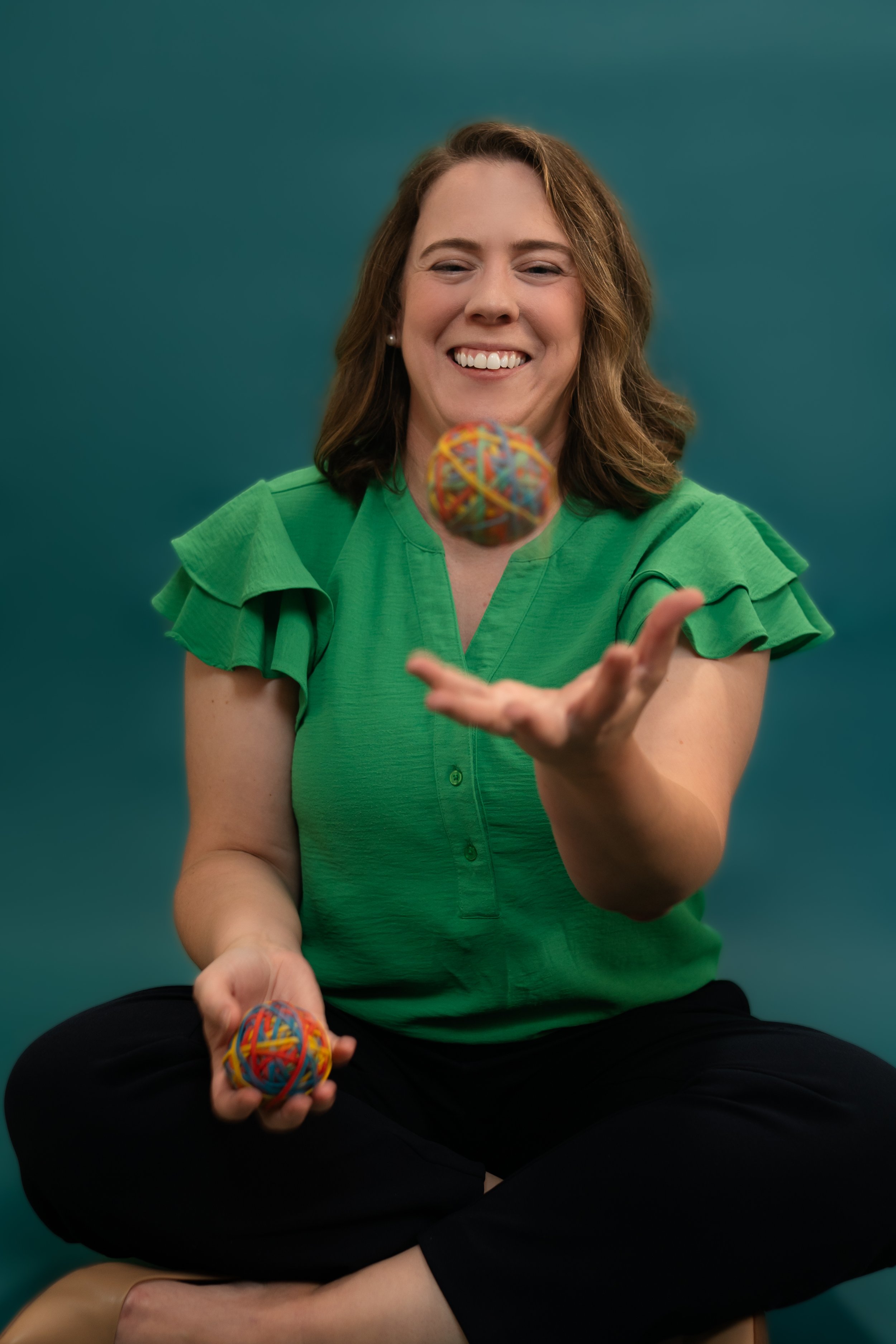 Amanda throwing a rubber band ball in the air.jpg