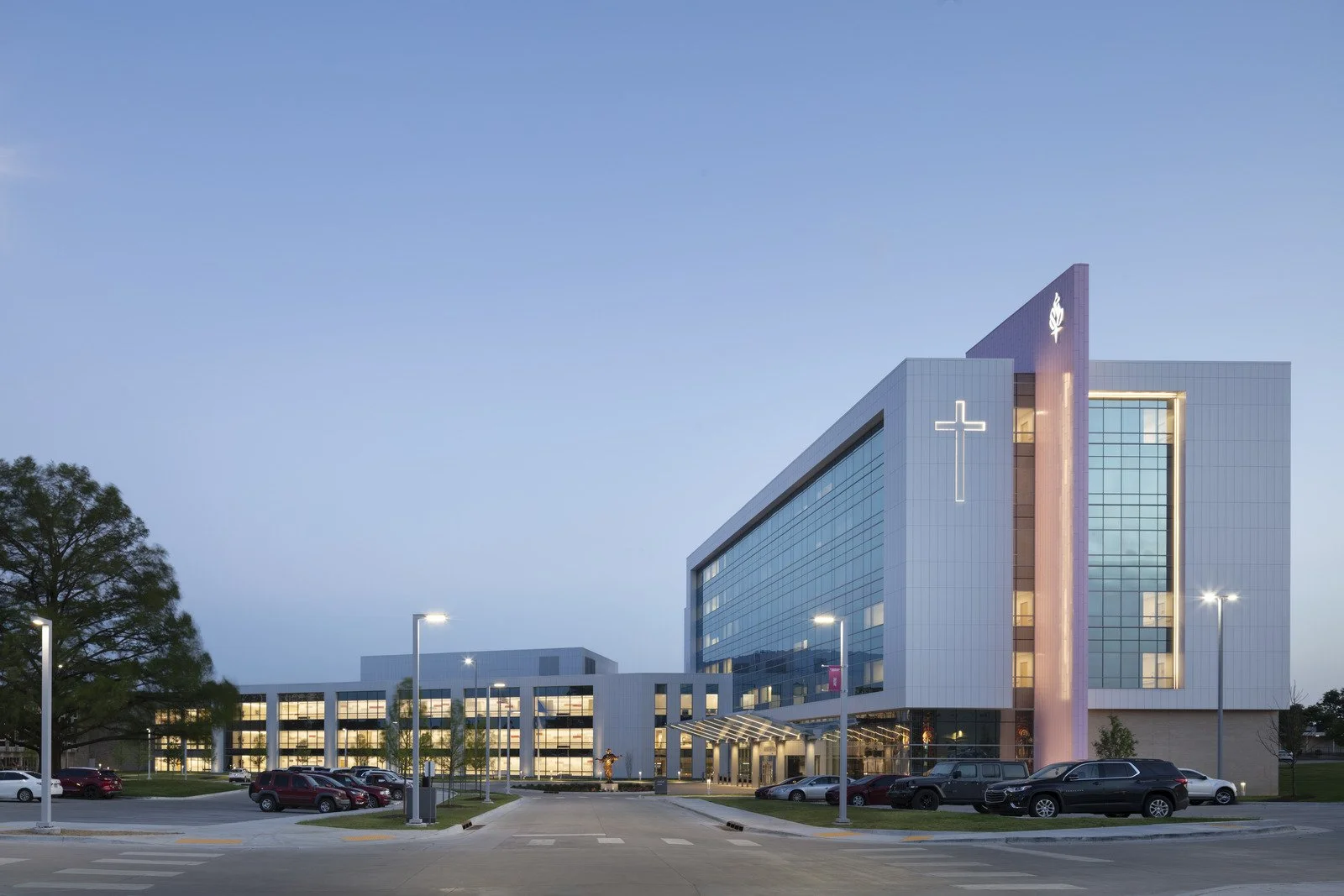Hospital building and parking lot at twilight