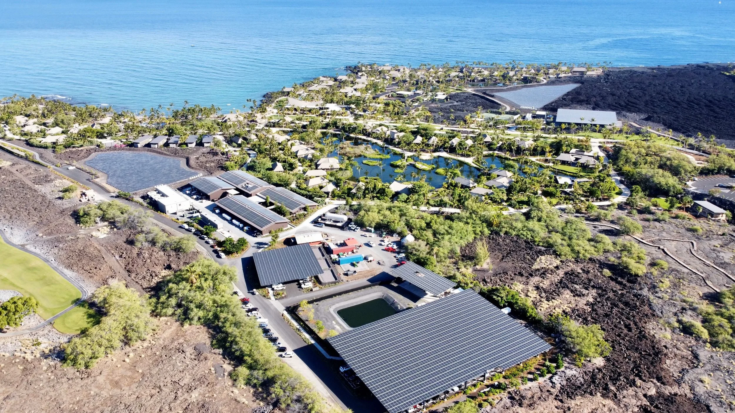 Aerial view of Kona Village Resort showing expansive solar panel rooflines on the property.