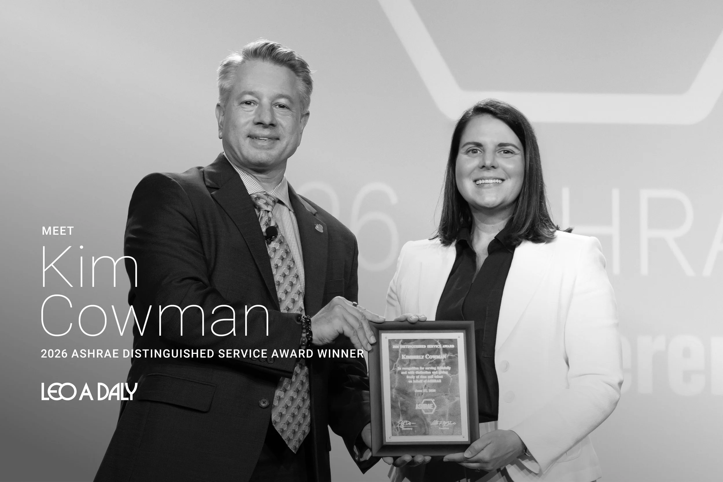 Kim Cowman, National Director of Engineering receiving the ASHRAE Distinguished Service Award on stage at annual gala.