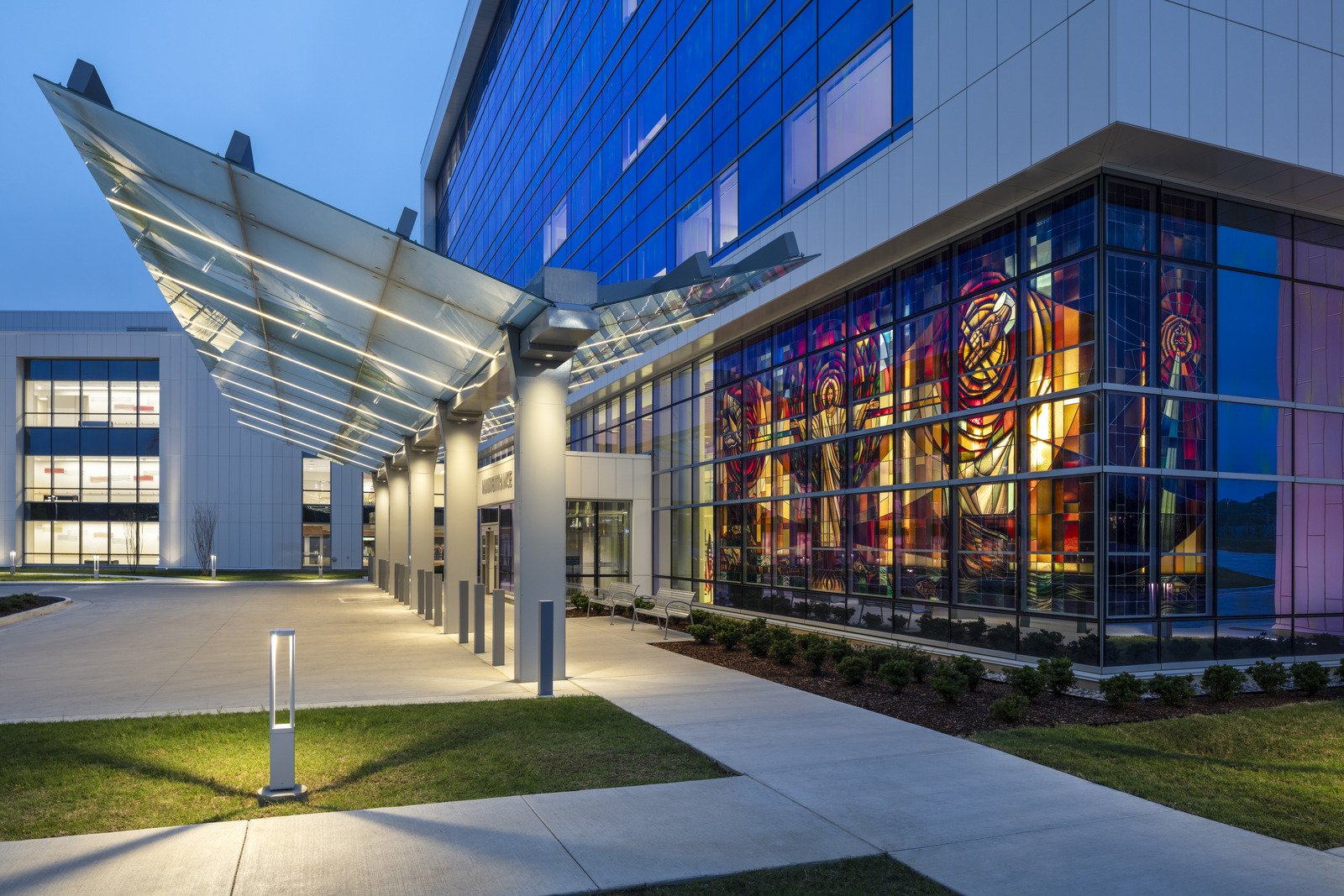 Entry walkway of St. Francis Muskogee hospital with chapel stained glass visible