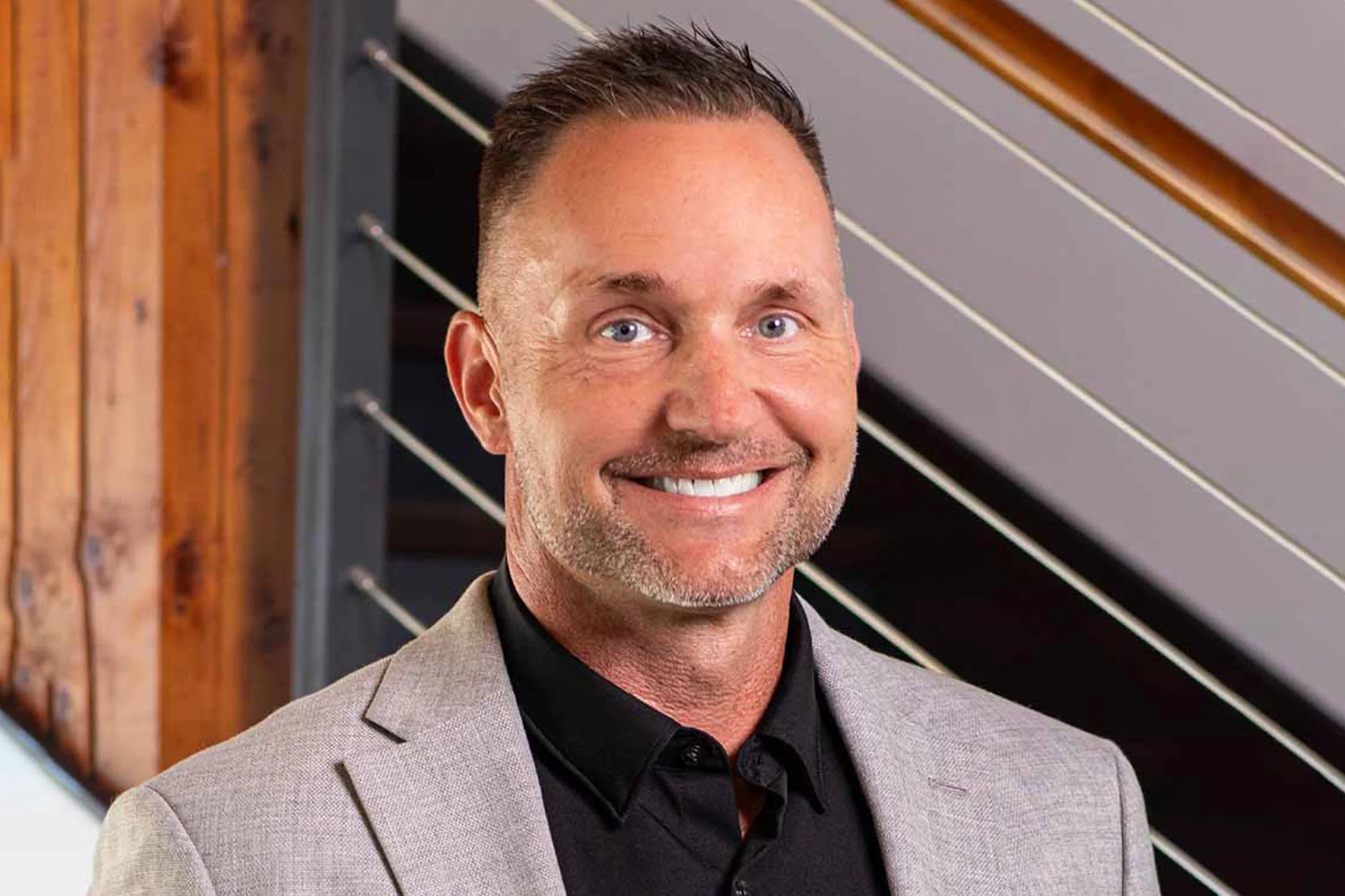 Michael McGuire in gray blazer