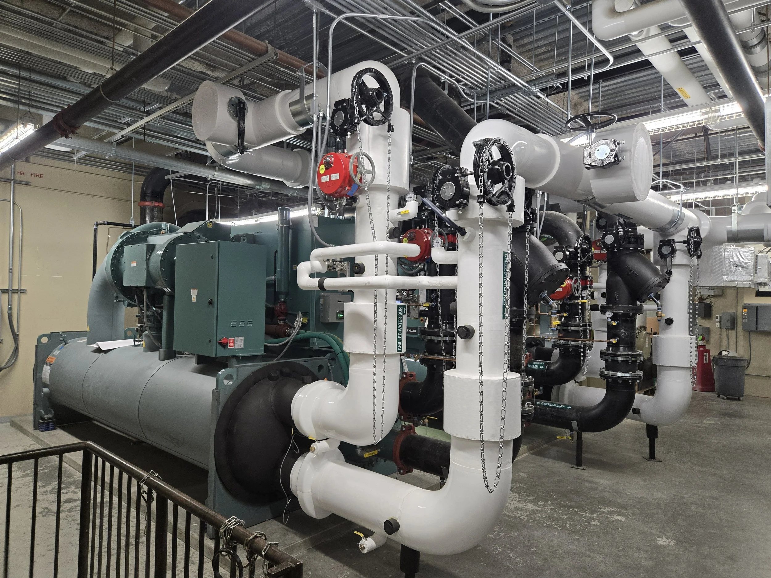 White pipes connect to green mechanical equipment