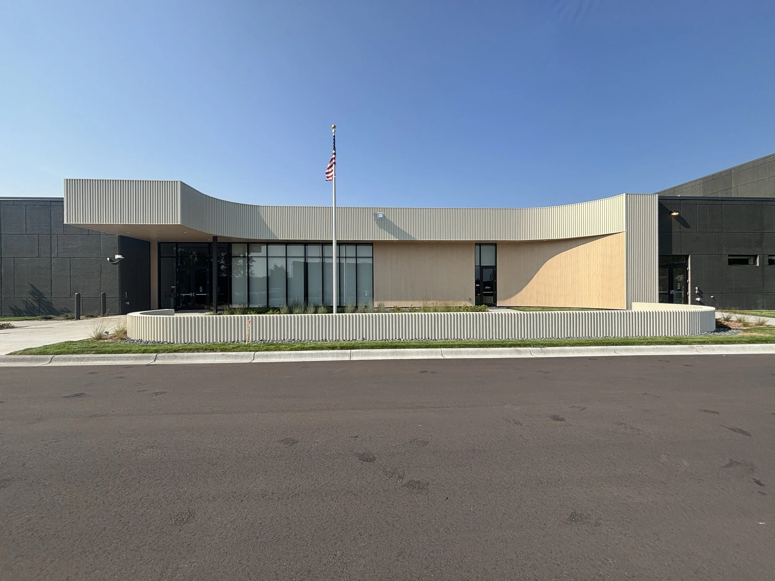 Lakeville's FiRST Center, a wide view of a building with an American flag in front