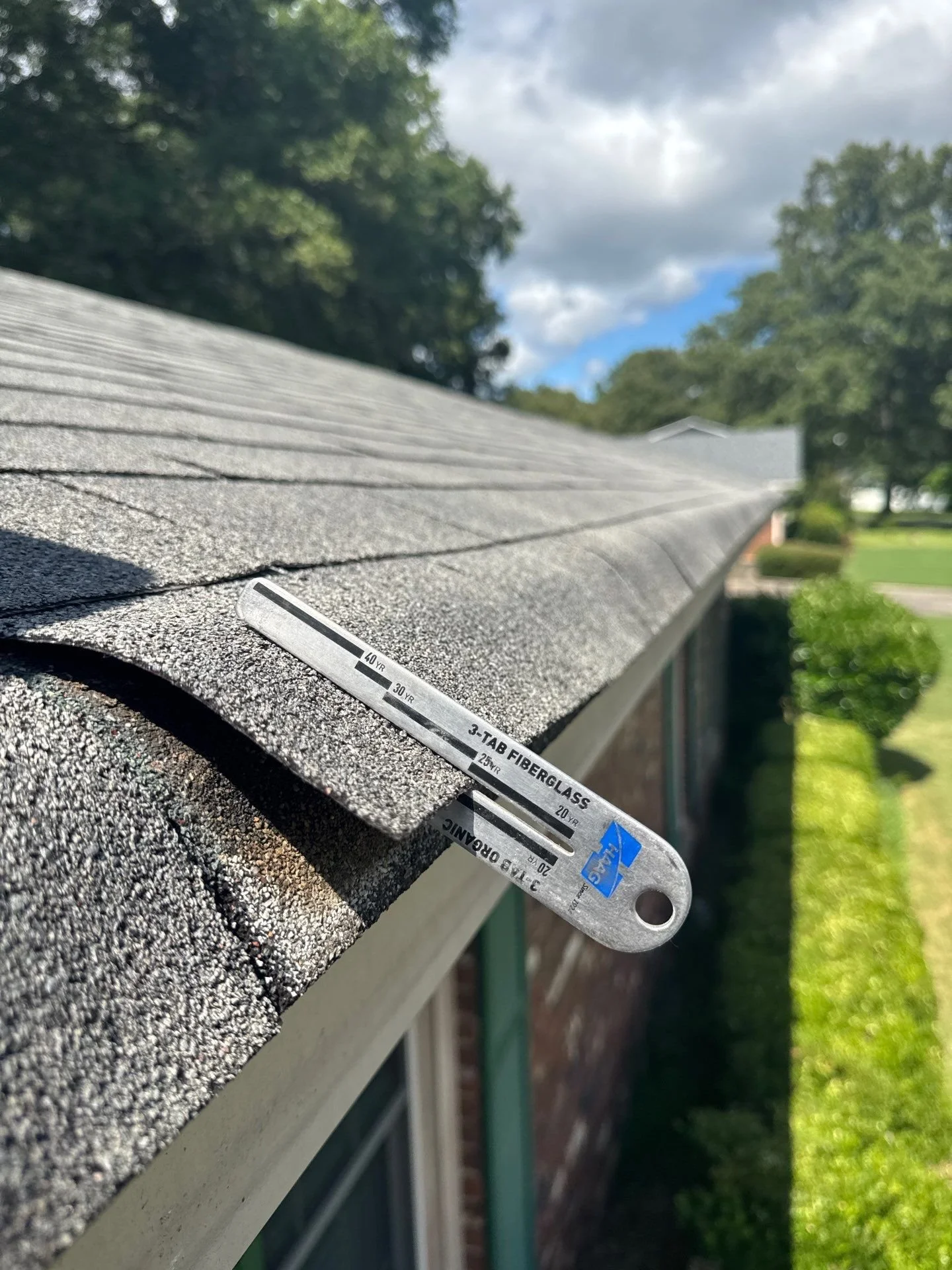 Close-up of a Haag shingle gauge used for transparent, evidence-based roof inspections in Rome, Georgia.