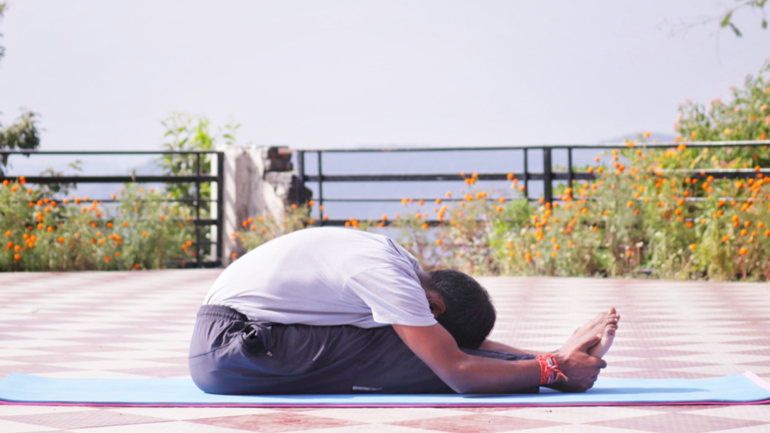 A person passively stretching their hamstring which this article advises against.