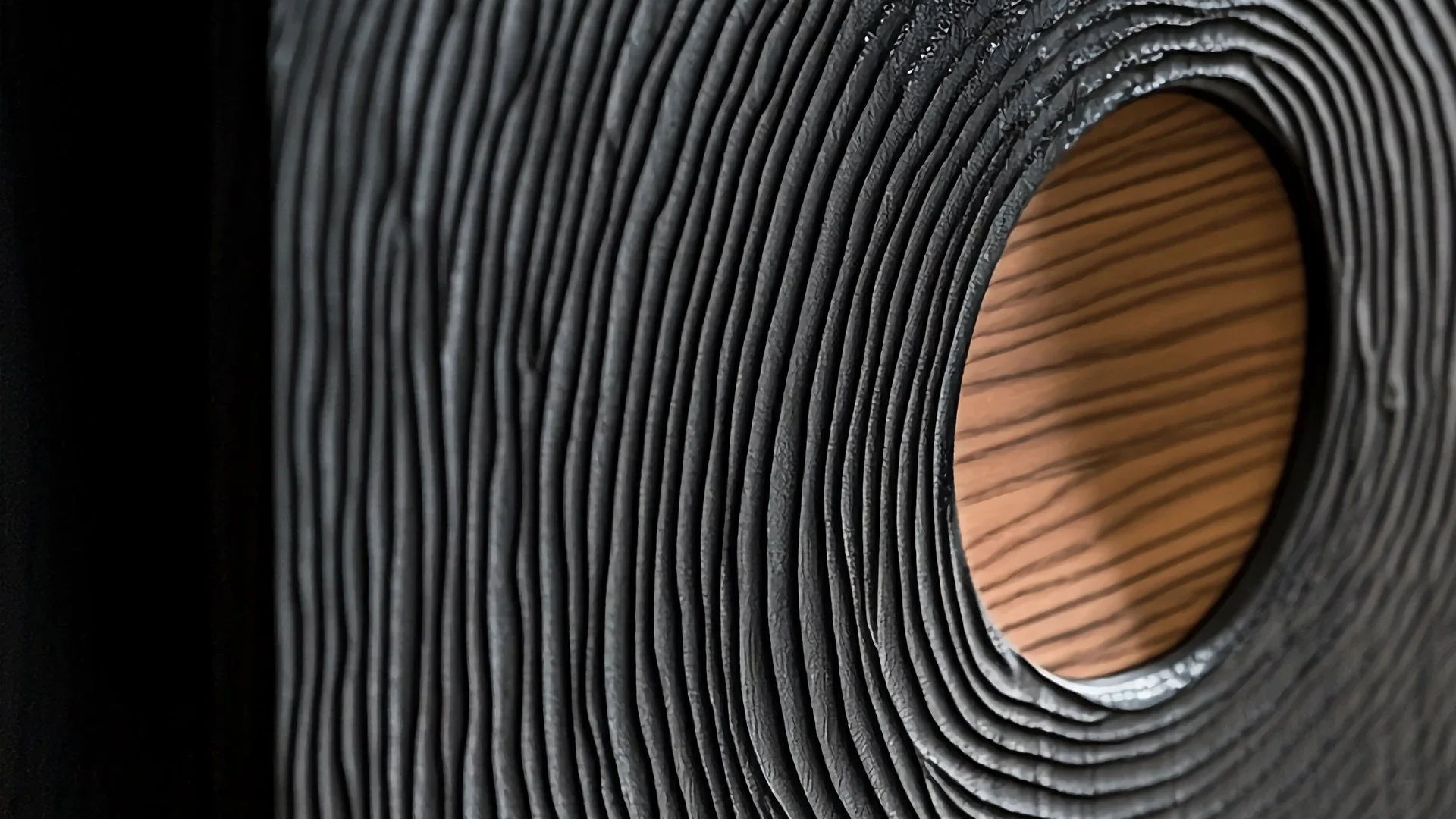 Textured black material with wood center