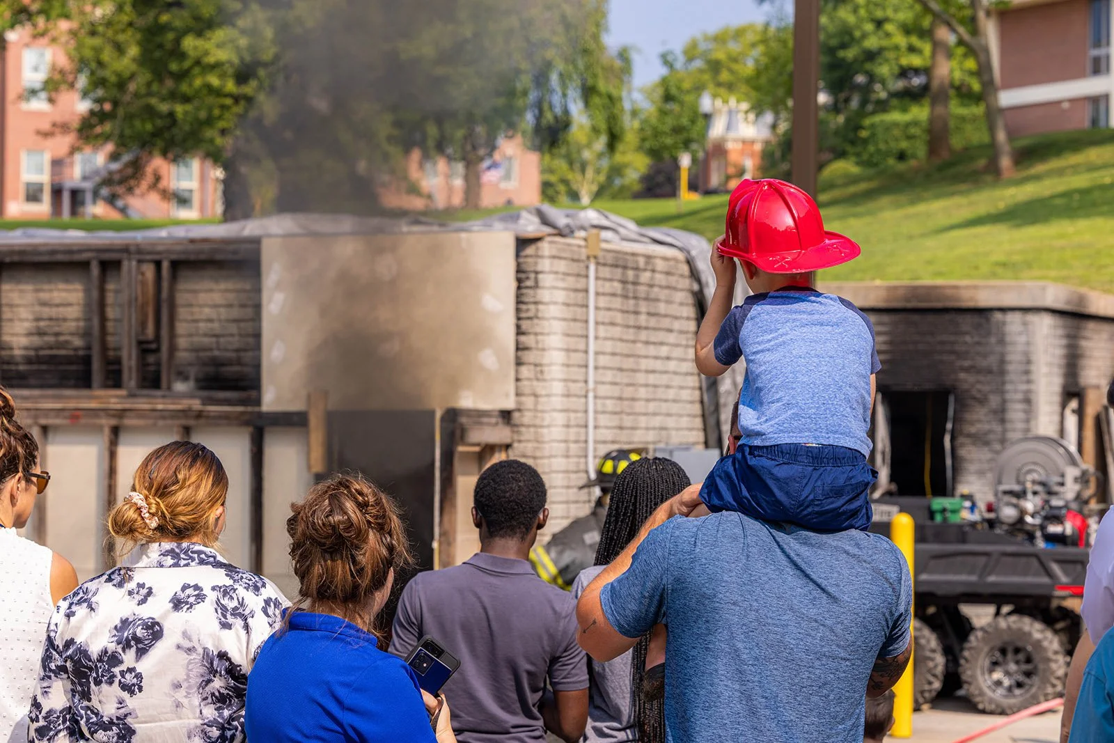 a future firefighter watches a demonstration burn at the National Emergency Training Center