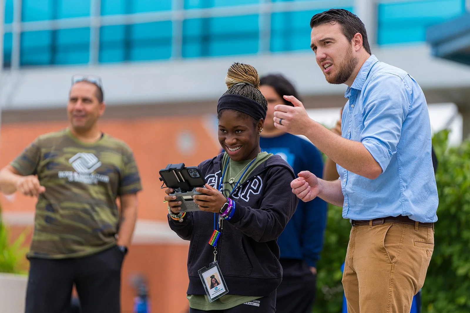 Jeremy Roop giving a drone flight lesson to a campus visitor