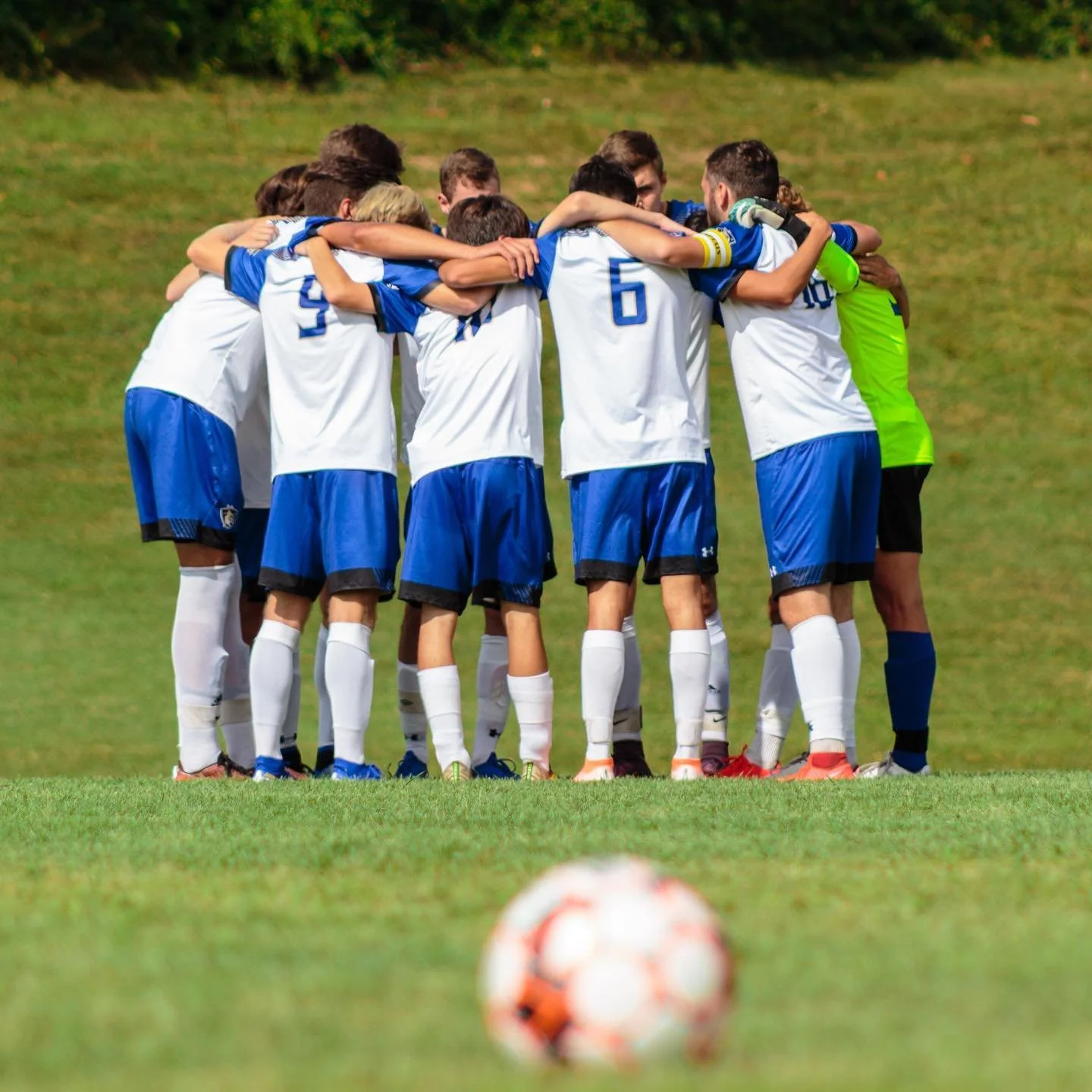 Carroll Community College men's soccer team huddled, midway through their inaugural home game