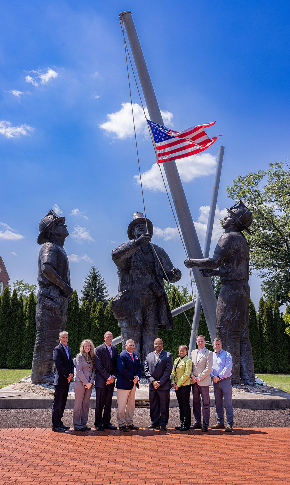 a group of people poses at the 9/11 memorial at the National Emergency Training Center