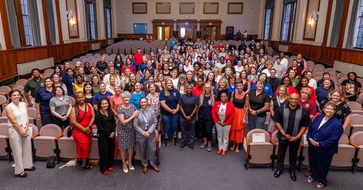 Large group of people in a conference room at NETC