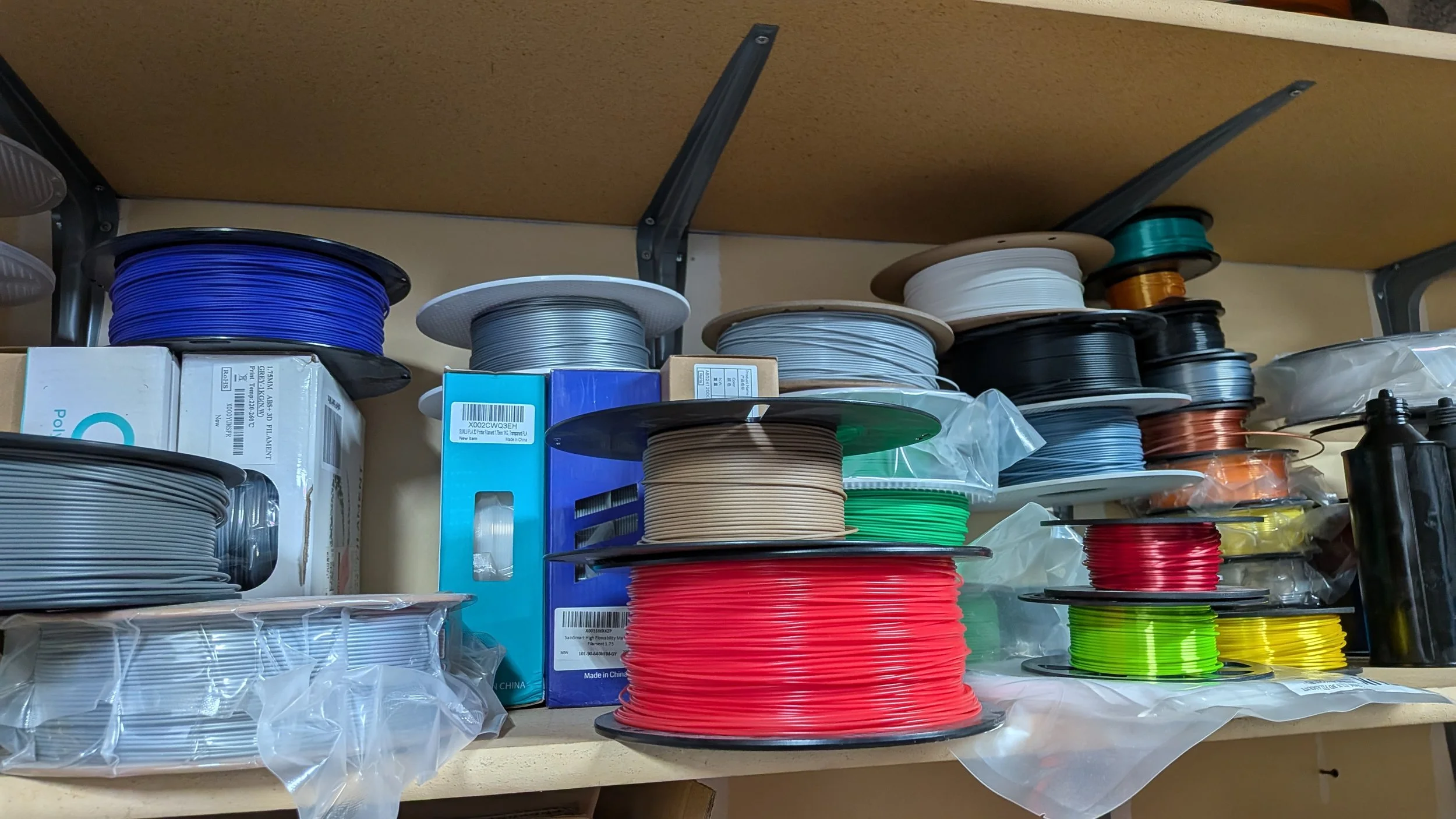 A variety of PLA filament textures and colors, with some PETG mixed in