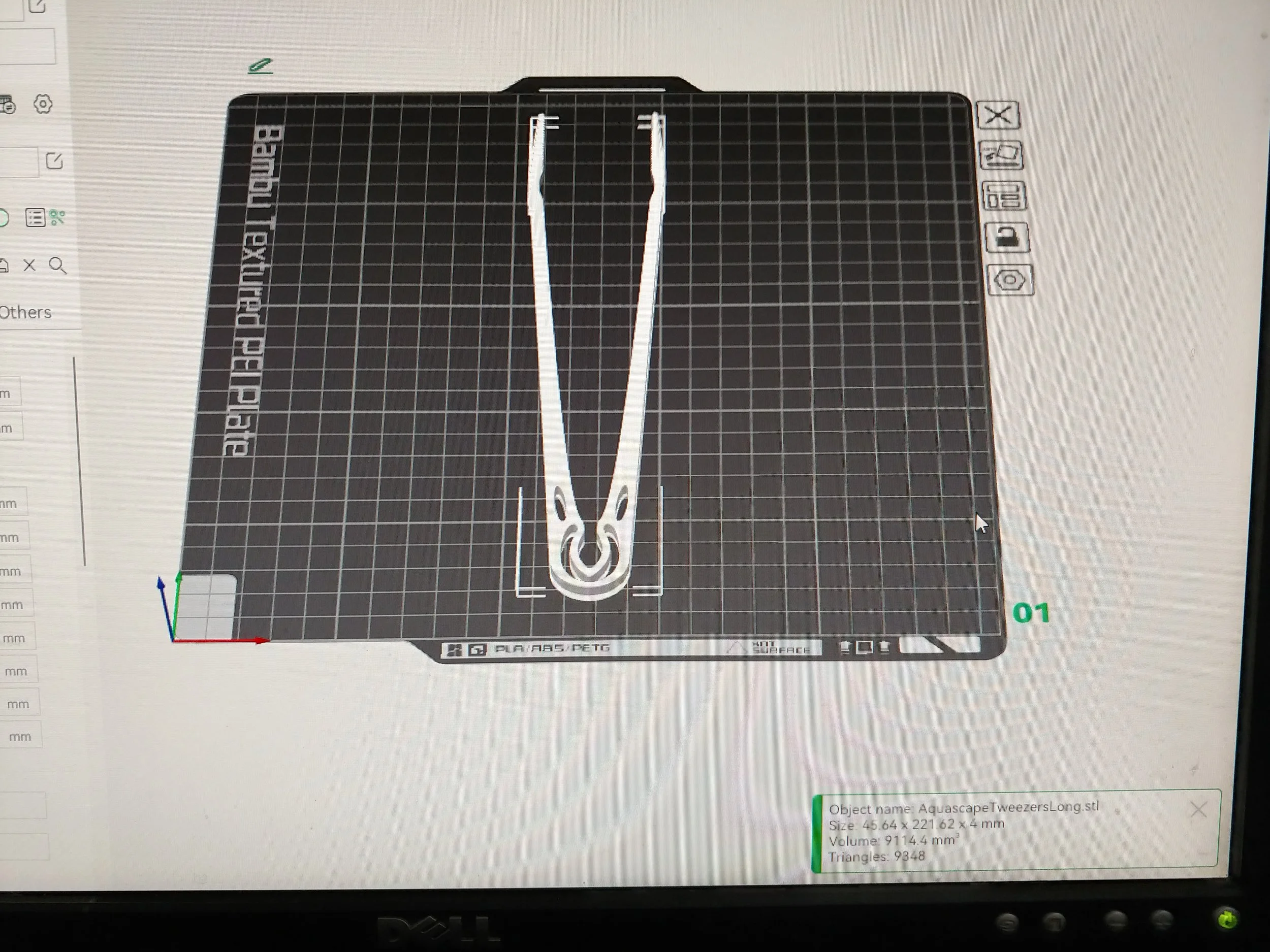 A long set of tweezers, with a rounded end on one side.