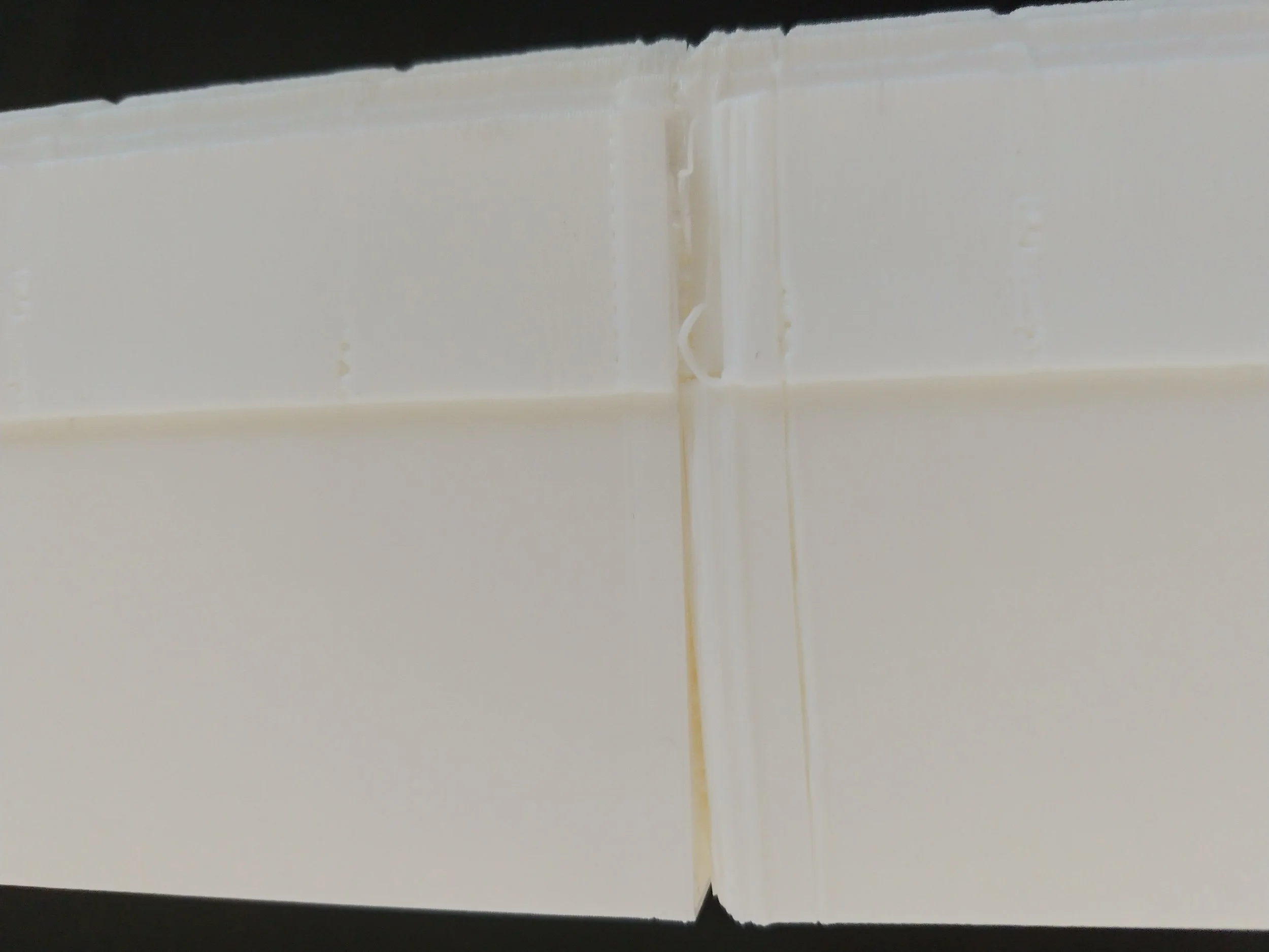 A huge crack appeared in the print where the plastic didn't stick.  There are broken off pieces of filamentin a couple of spots, and layer lines are uneven.