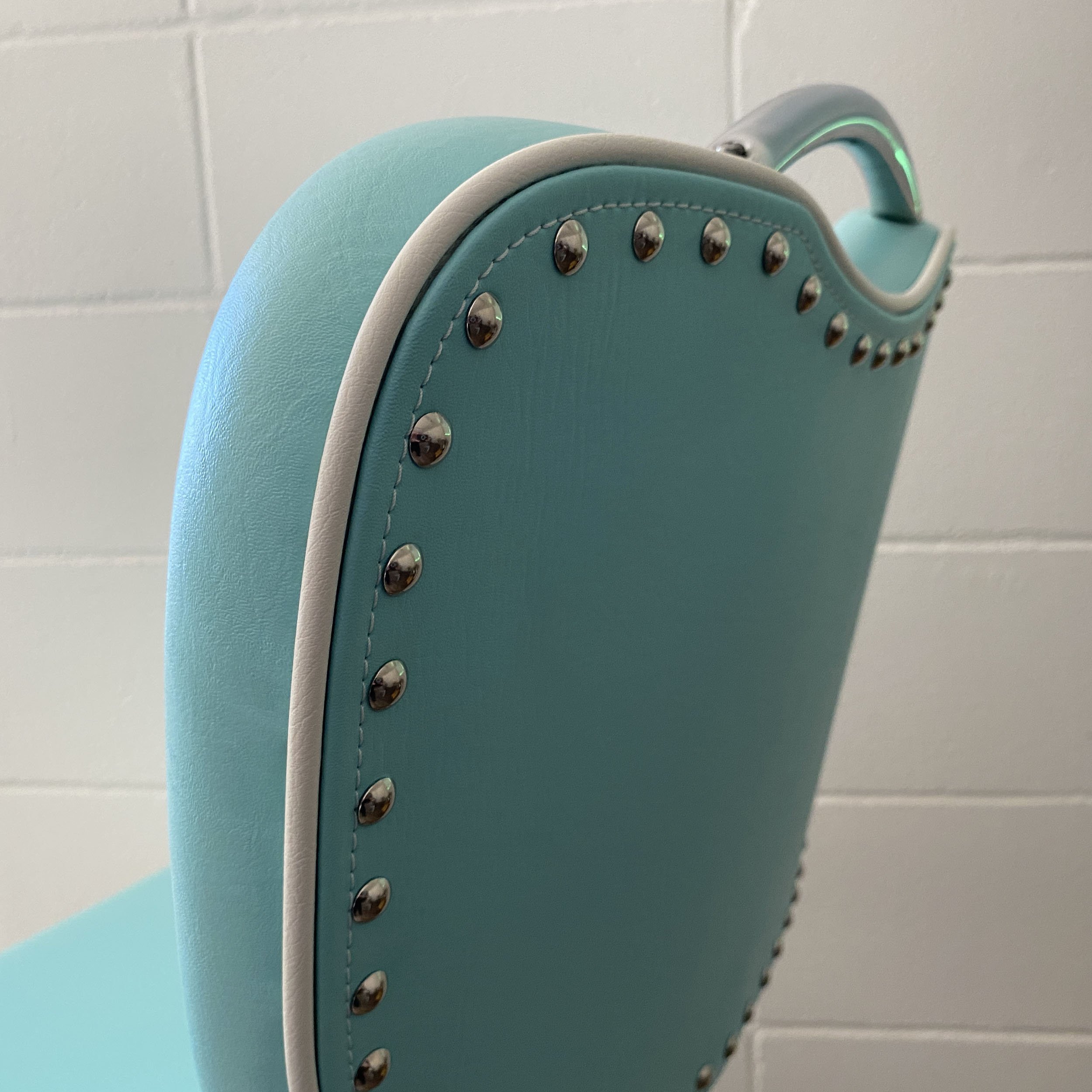 retro dining chairs - back piping and decorative tacks detail