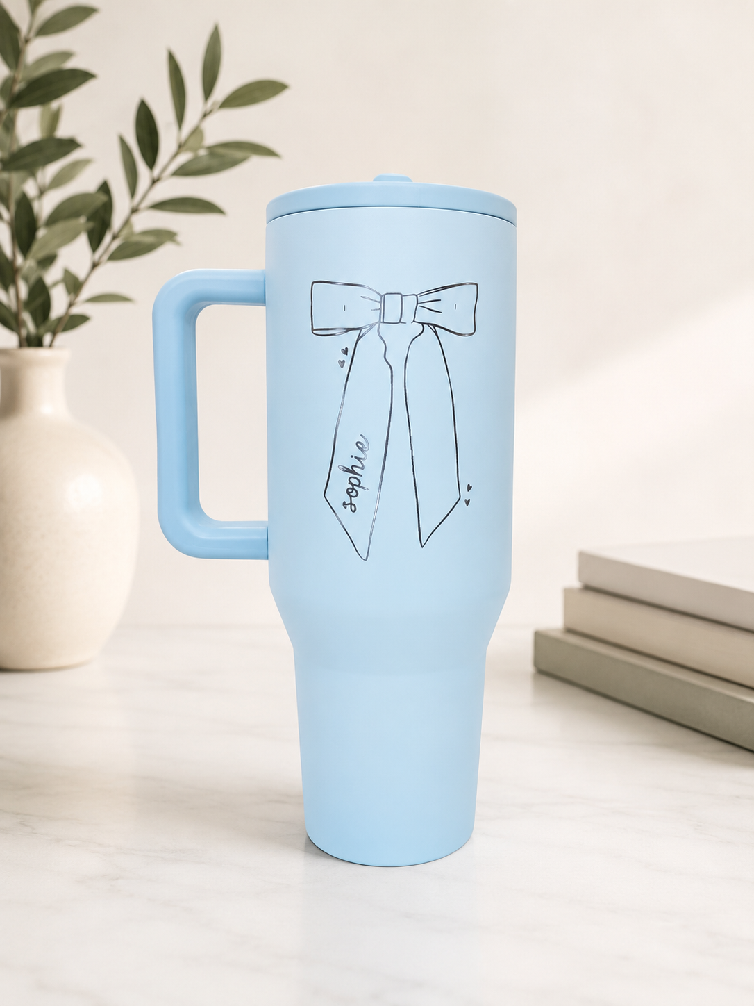 Custom laser engraved Hydrojug tumbler with personalized name and bow.
