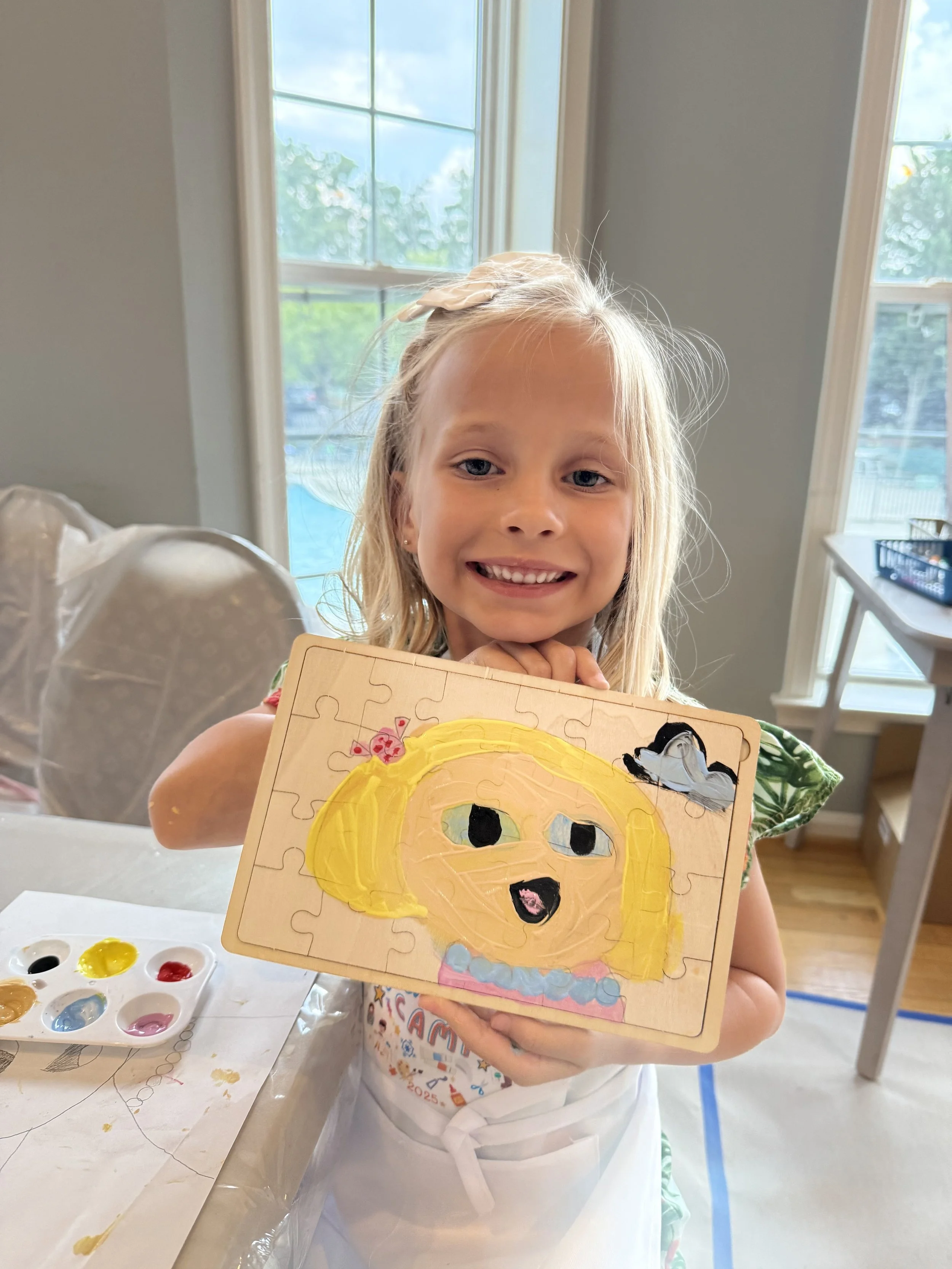 A child showing a painting in an art class in loudoun county, virginia