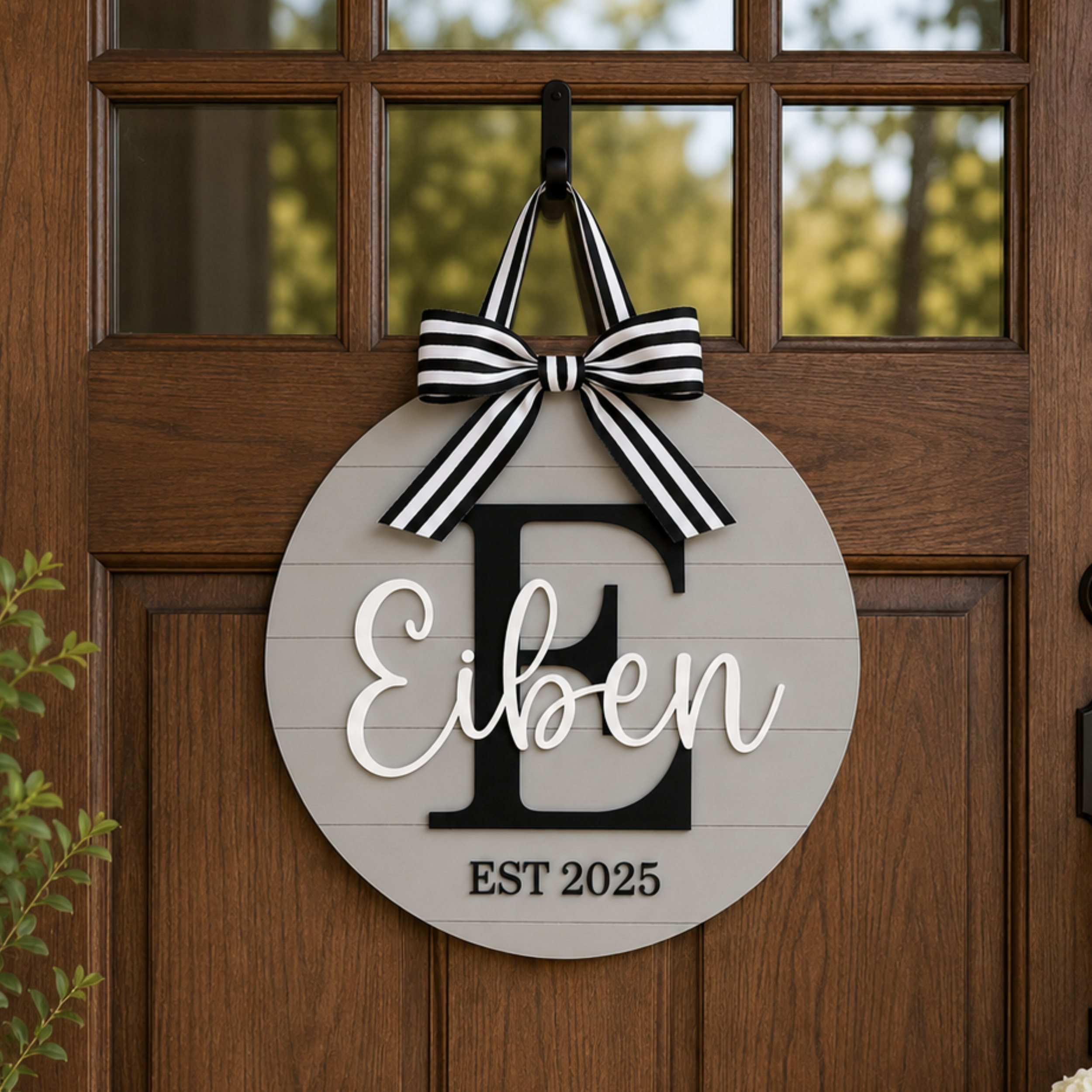 Custom laser cut wood front door sign with family name.