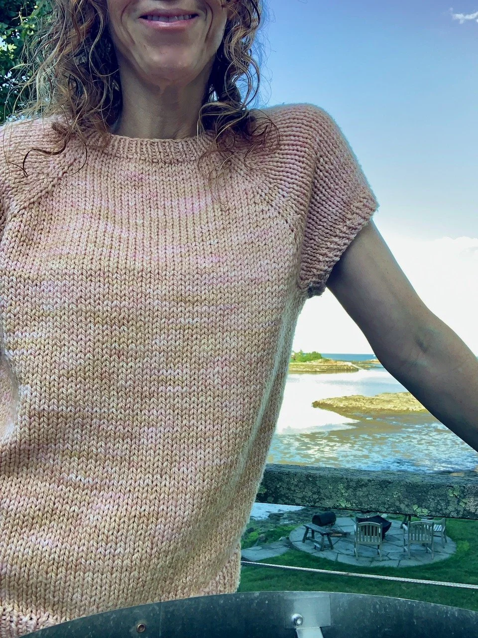 pink northwestern leaning on balcony railing.jpeg