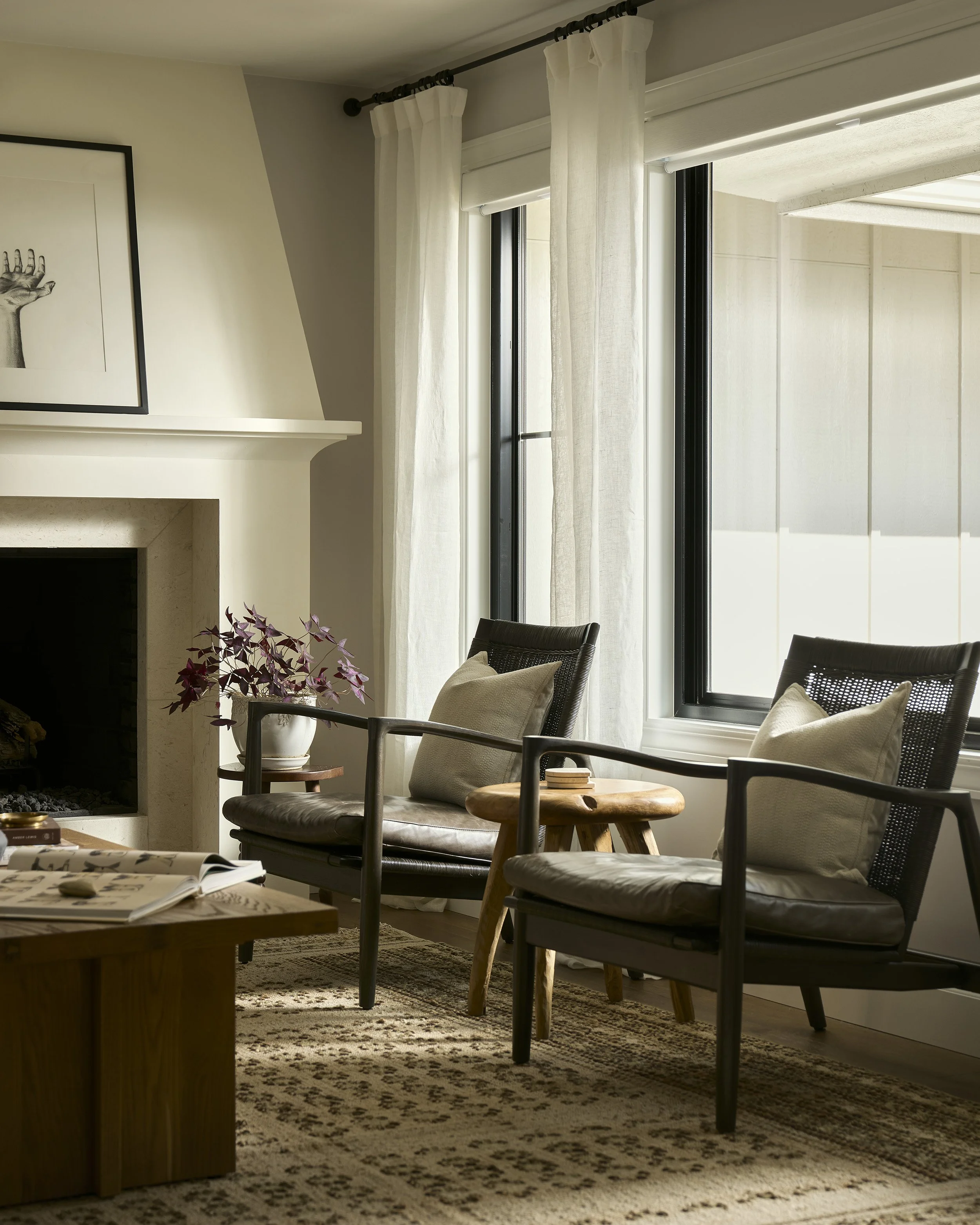 Cozy seating area with woven lounge chairs and natural light in Denver living room remodel