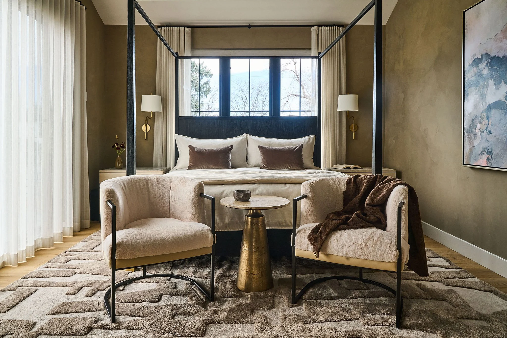 Warm, modern primary bedroom with roman clay walls, soft neutral palette, and layered textures creating a calm, elevated retreat