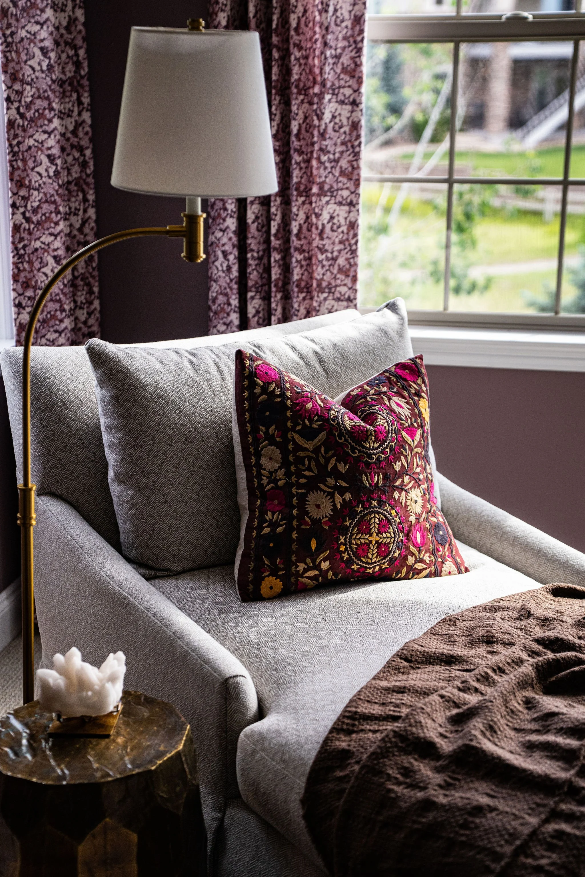 chaise lounge with purple embroidered pillow