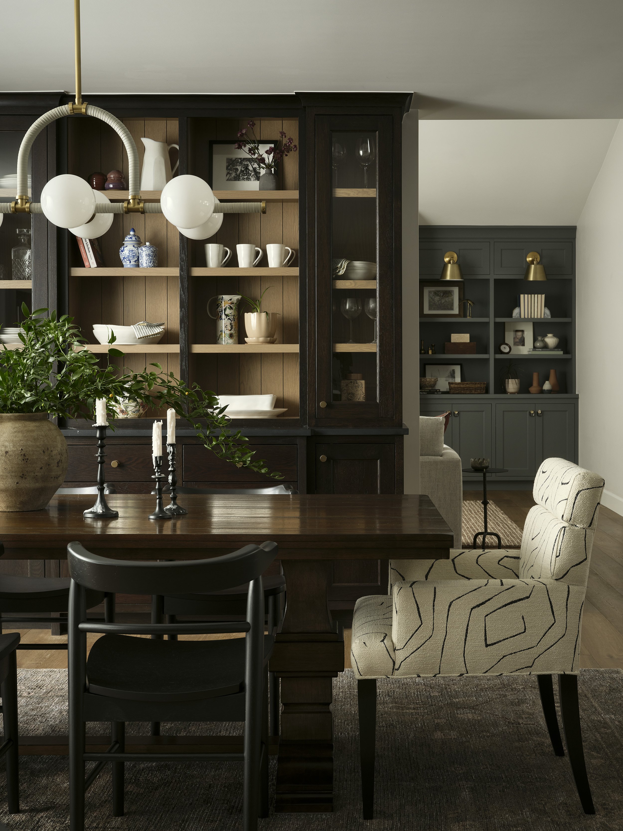 built in cabinets dining room with black and modern chandelier