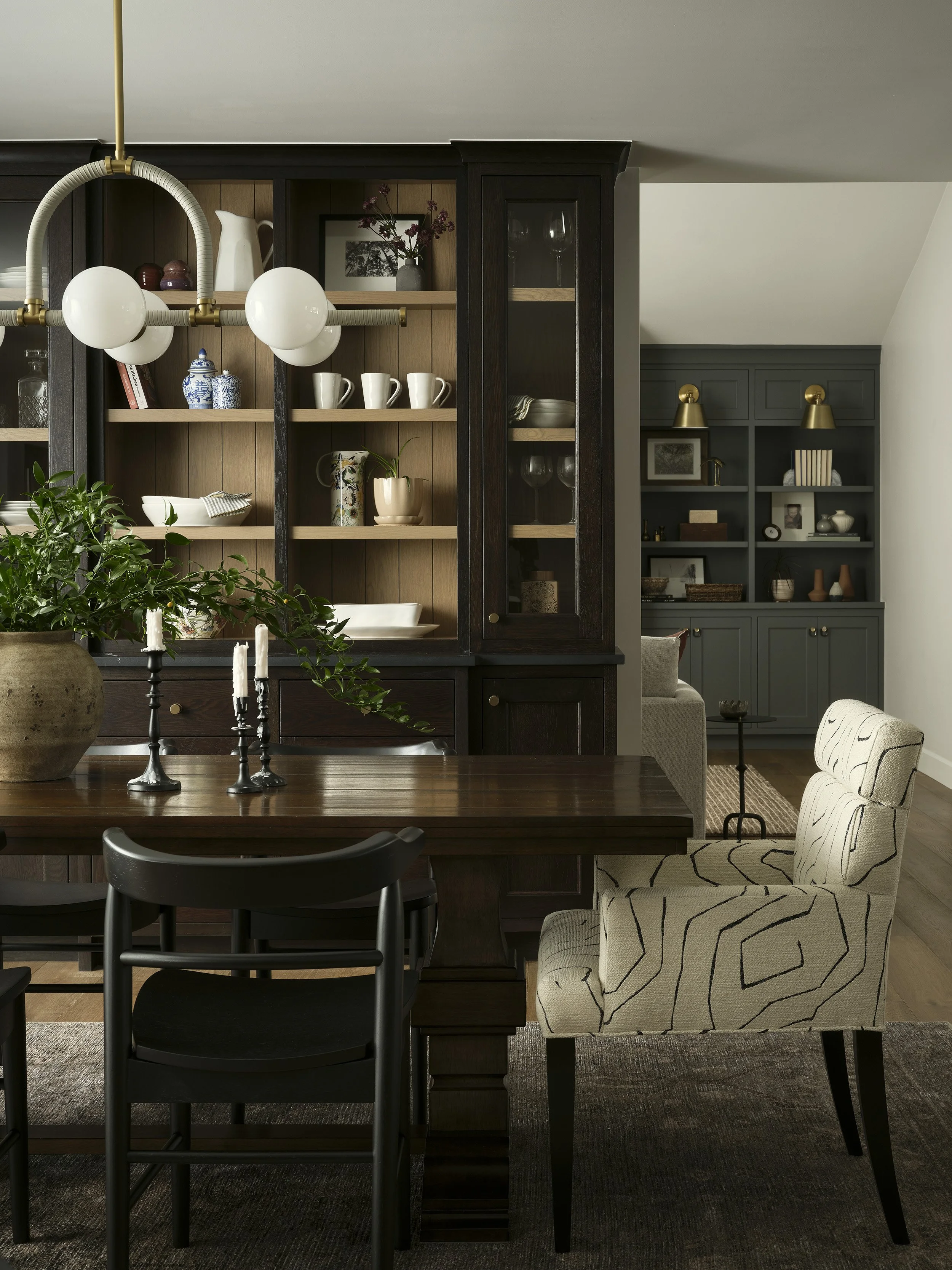 Dining room with dark built-in cabinetry and warm wood finishes in Denver home renovation