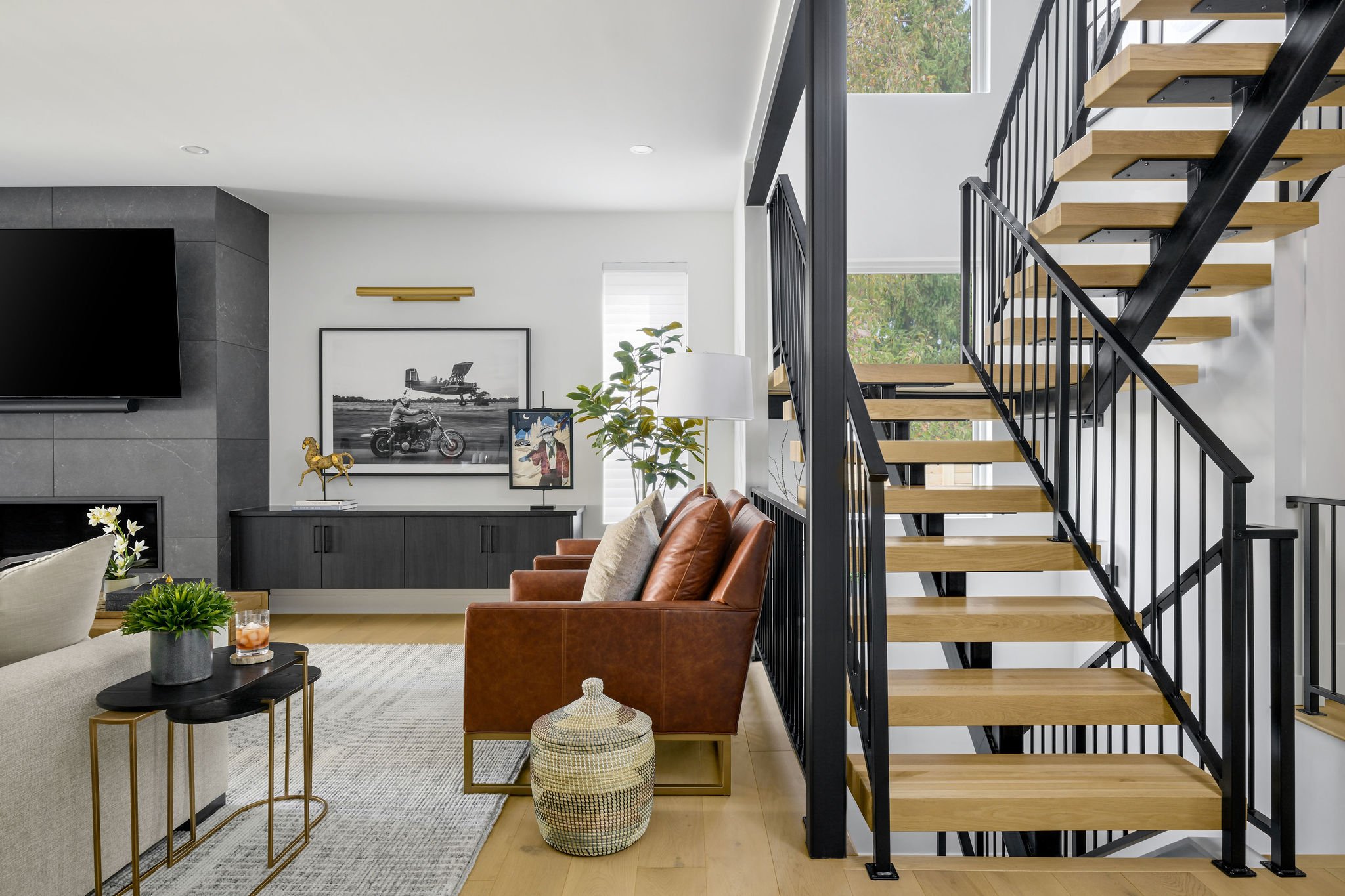 neutral living room with leather chairs and modern railing