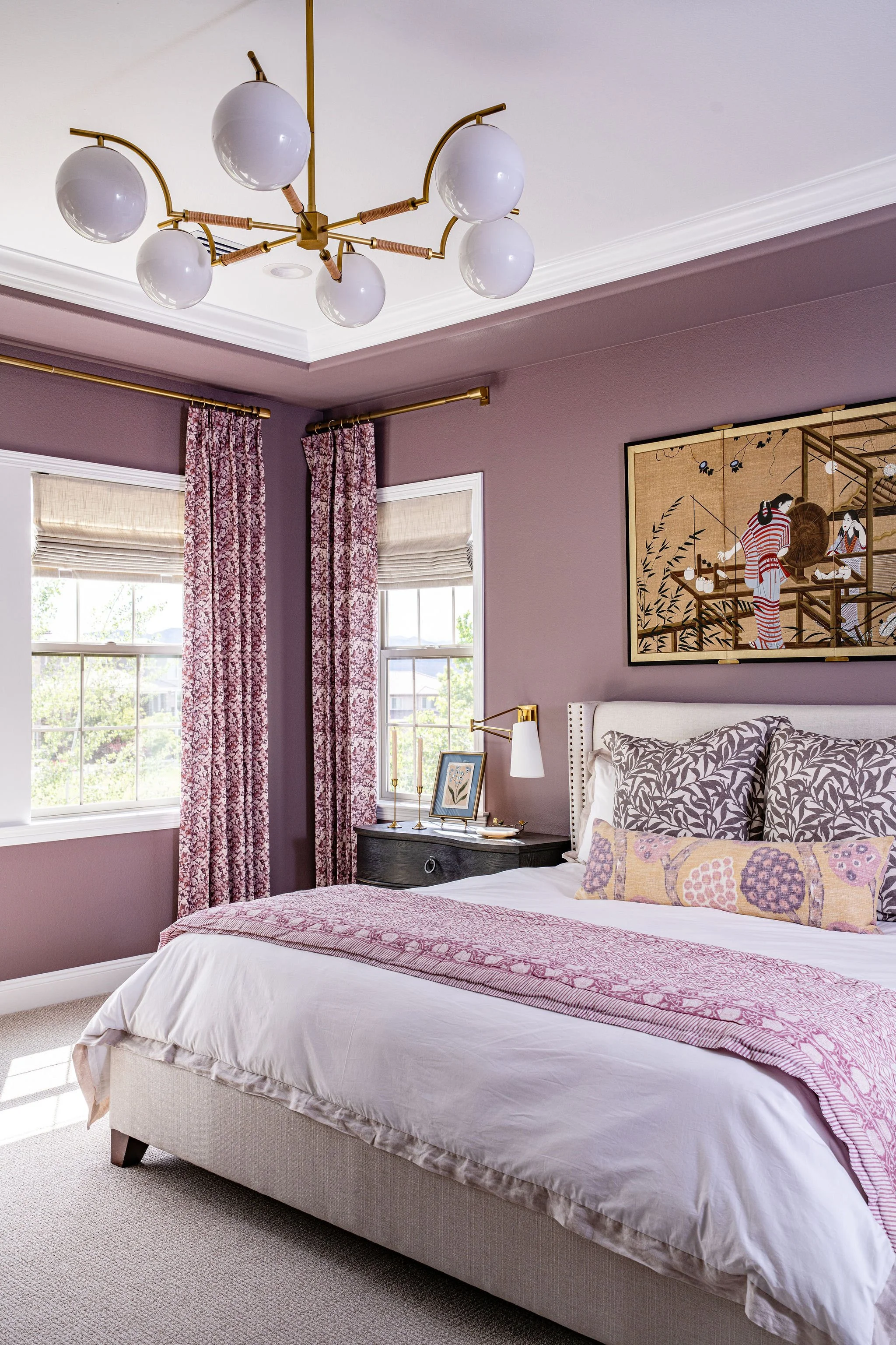 purple primary bedroom with purple floral drapes and japanese art
