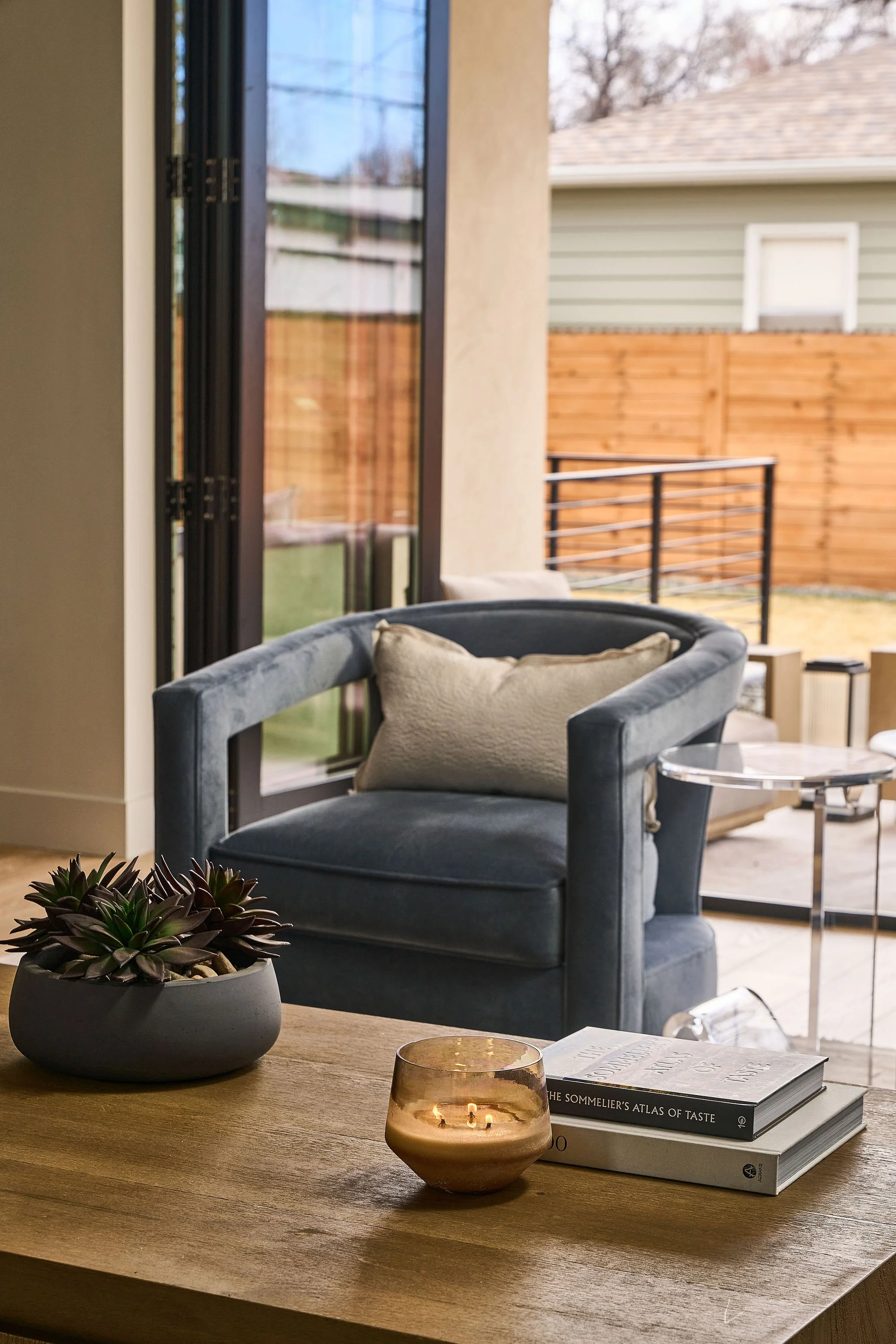 Velvet accent chair styled beside sliding glass doors in Denver living room