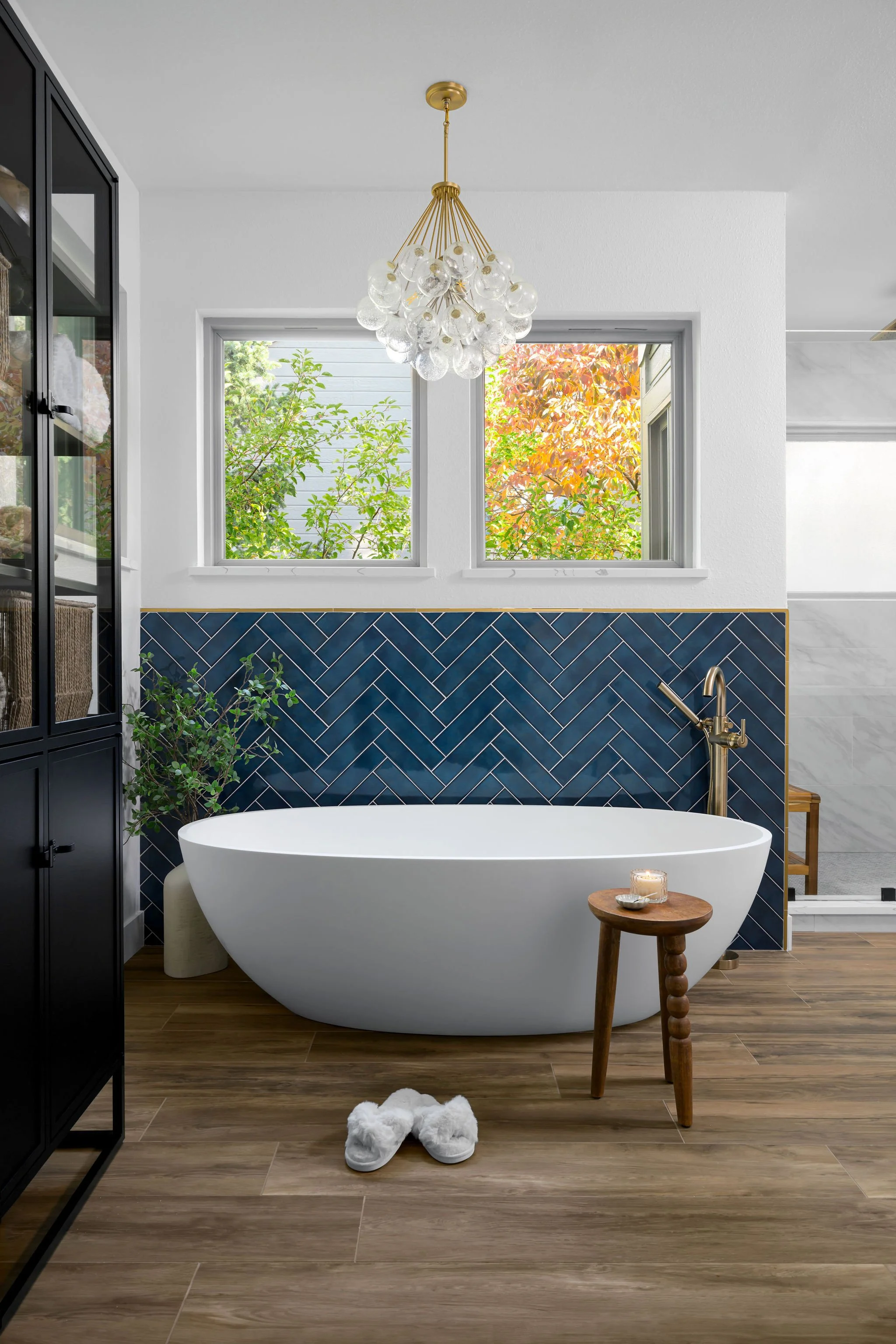Freestanding tub with blue herringbone tile and oversized shower in Highlands Ranch primary bathroom renovation