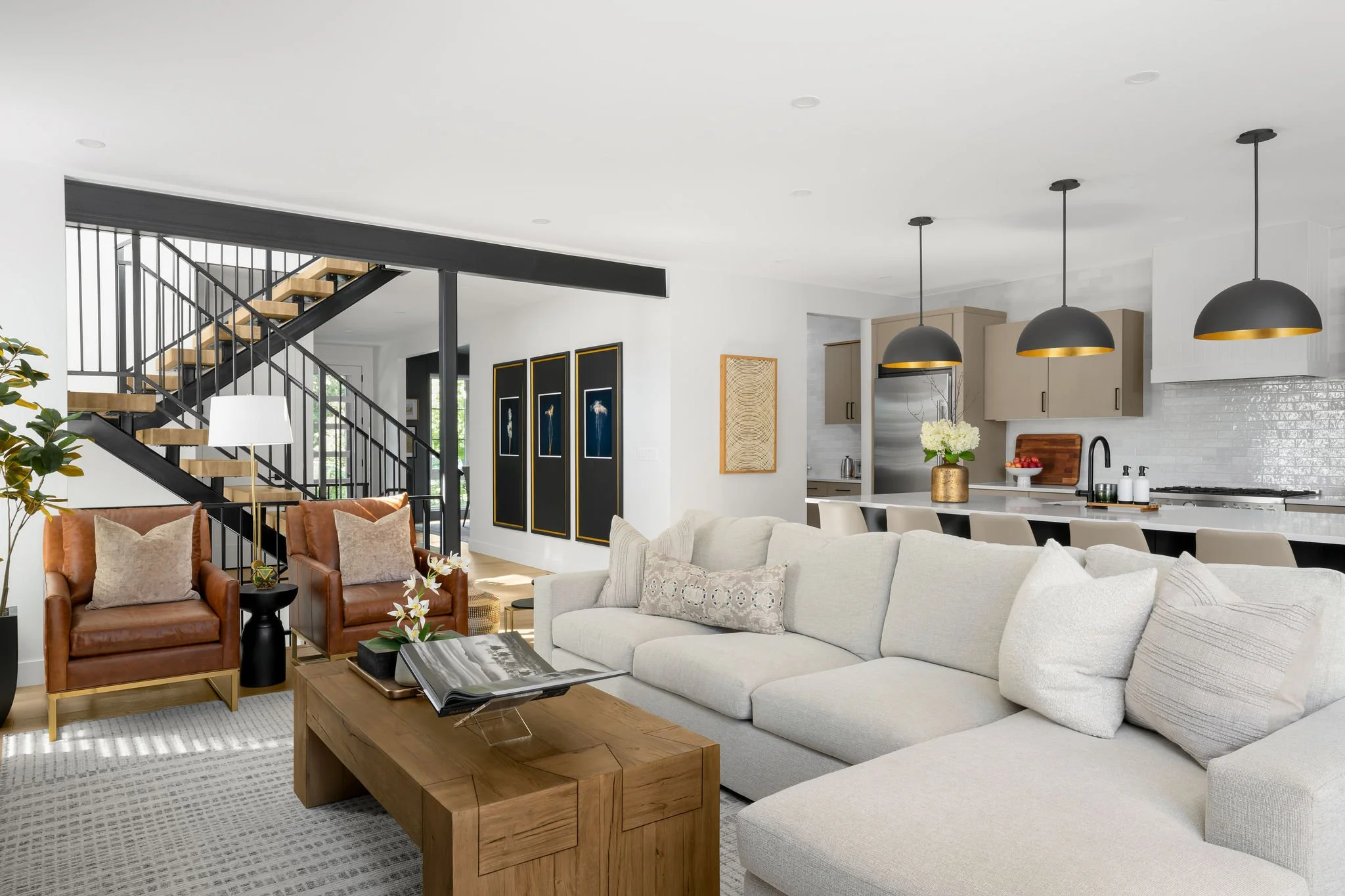 light sectional with wood coffee table and leather chairs