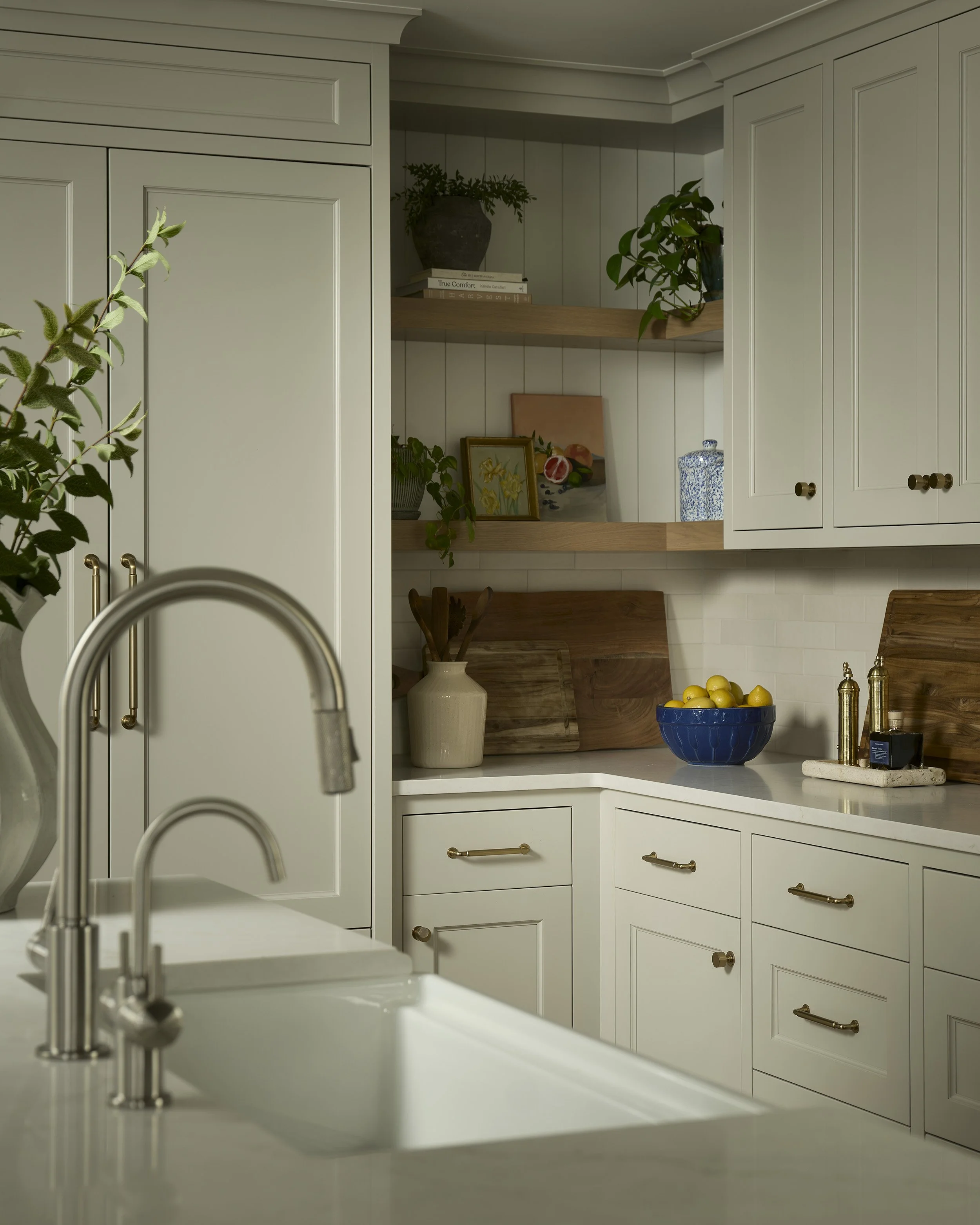 Kitchen detail with custom cabinetry, open shelving, and brass hardware in Denver remodel