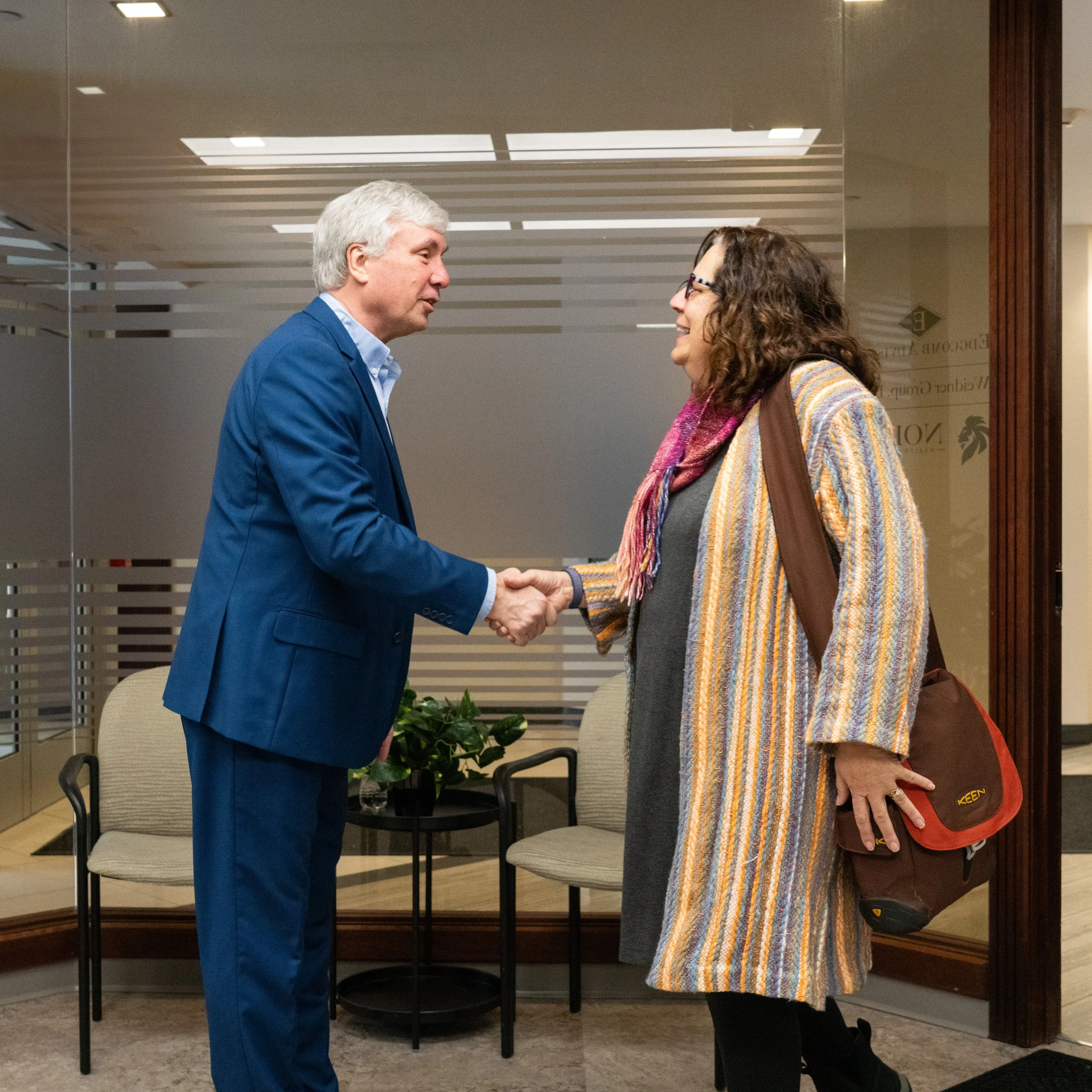 Weidner Sorge Wealth Partners advisor welcoming a client with a handshake in the firm's office, reflecting a personalized and relationship-focused approach to wealth management.