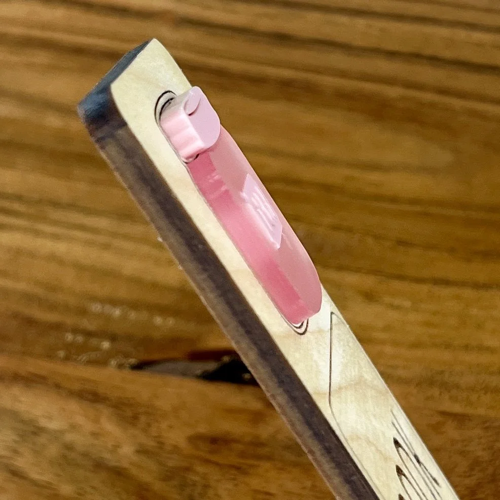 angled view maple wood bookmark with layered pink acrylic TBR jar detail and engraved reader quote "Book Junkie".