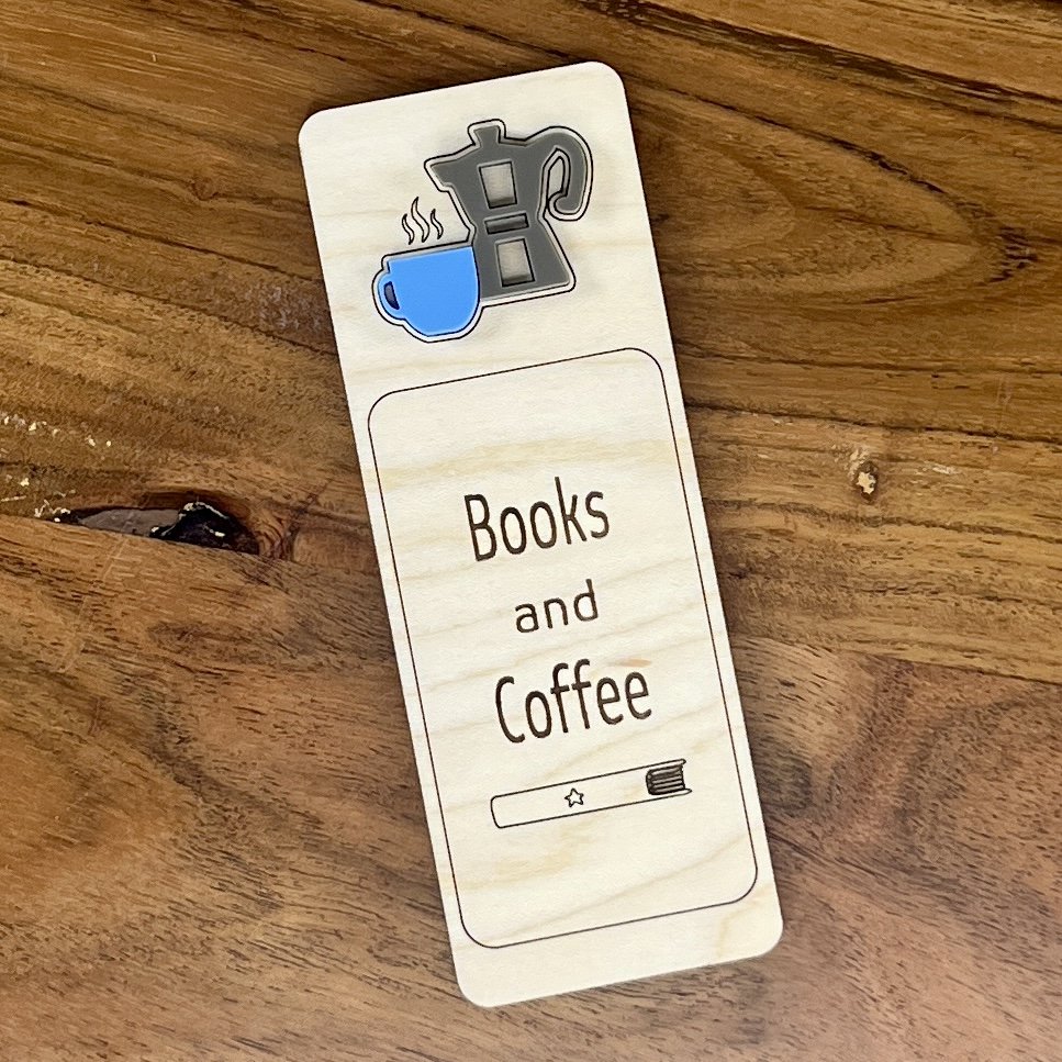 flat lay maple bookmark featuring blue acrylic coffee cup and stovetop coffee pot embellishment engraved with the phrase "Books and Coffee".