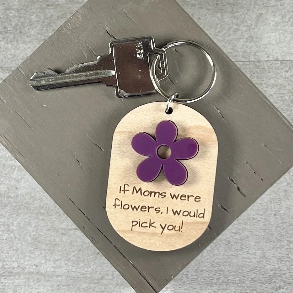 lifestyle shot of laser cut maple wood keychain showing matte acrylic sugar plum coloured flower If Mom Were Flowers Mother's Day gift Canada.