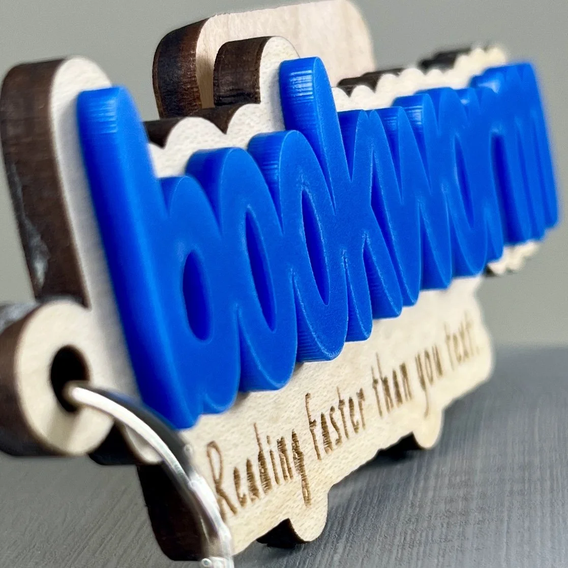Angled close up wood backpack tag cobalt blue acrylic "Bookworm" book lovers gift