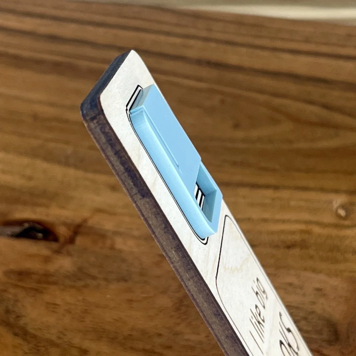 angled view maple bookmark featuring an acrylic book engraved with the phrase "I like big books and I cannot lie”.